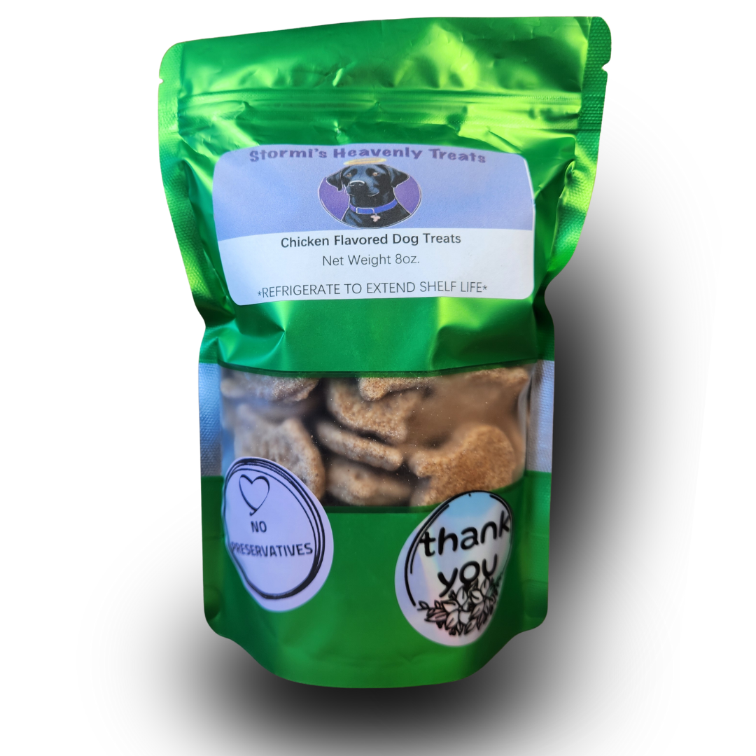 Green bag of Stormi's Heavenly Treats chicken-flavored dog treats with transparent window showing bone-shaped treats and labels reading 'No Preservatives' and 'thank you'.