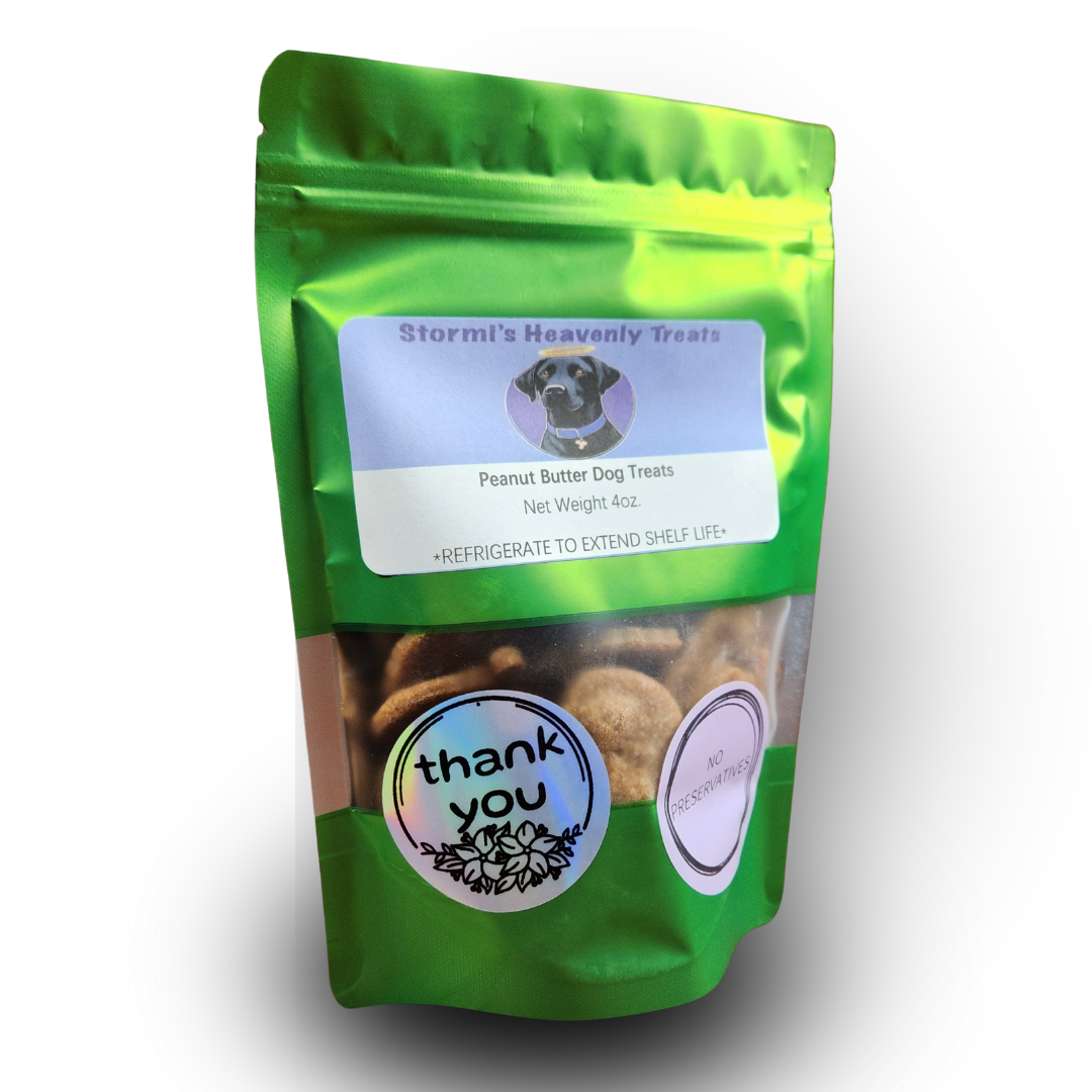 Green resealable bag of Stormi's Heavenly Treats peanut butter dog treats with labels showing net weight 4oz, thank you, and no preservatives.