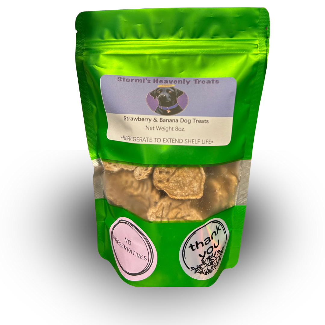 Green resealable bag of Stormi's Heavenly Treats Strawberry & Banana dog treats, showing net weight 8 oz and labels saying no preservatives and thank you.