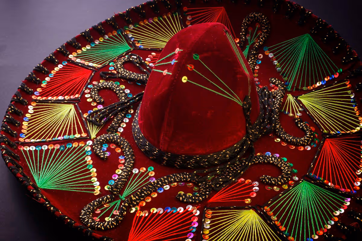 Traditional Mexican red hat  with green and yellow embroidery.