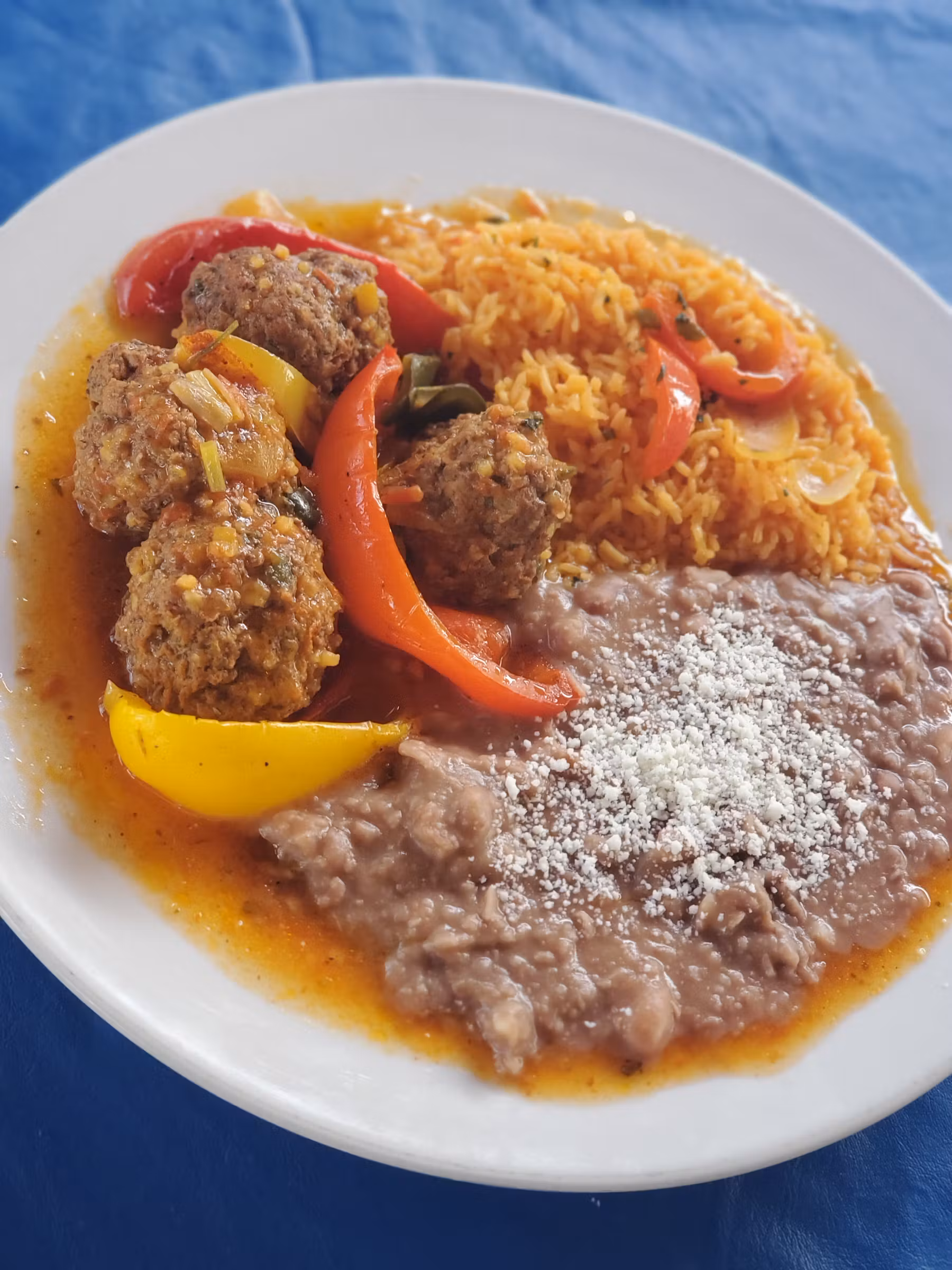 Meatballs served with rice and beans.