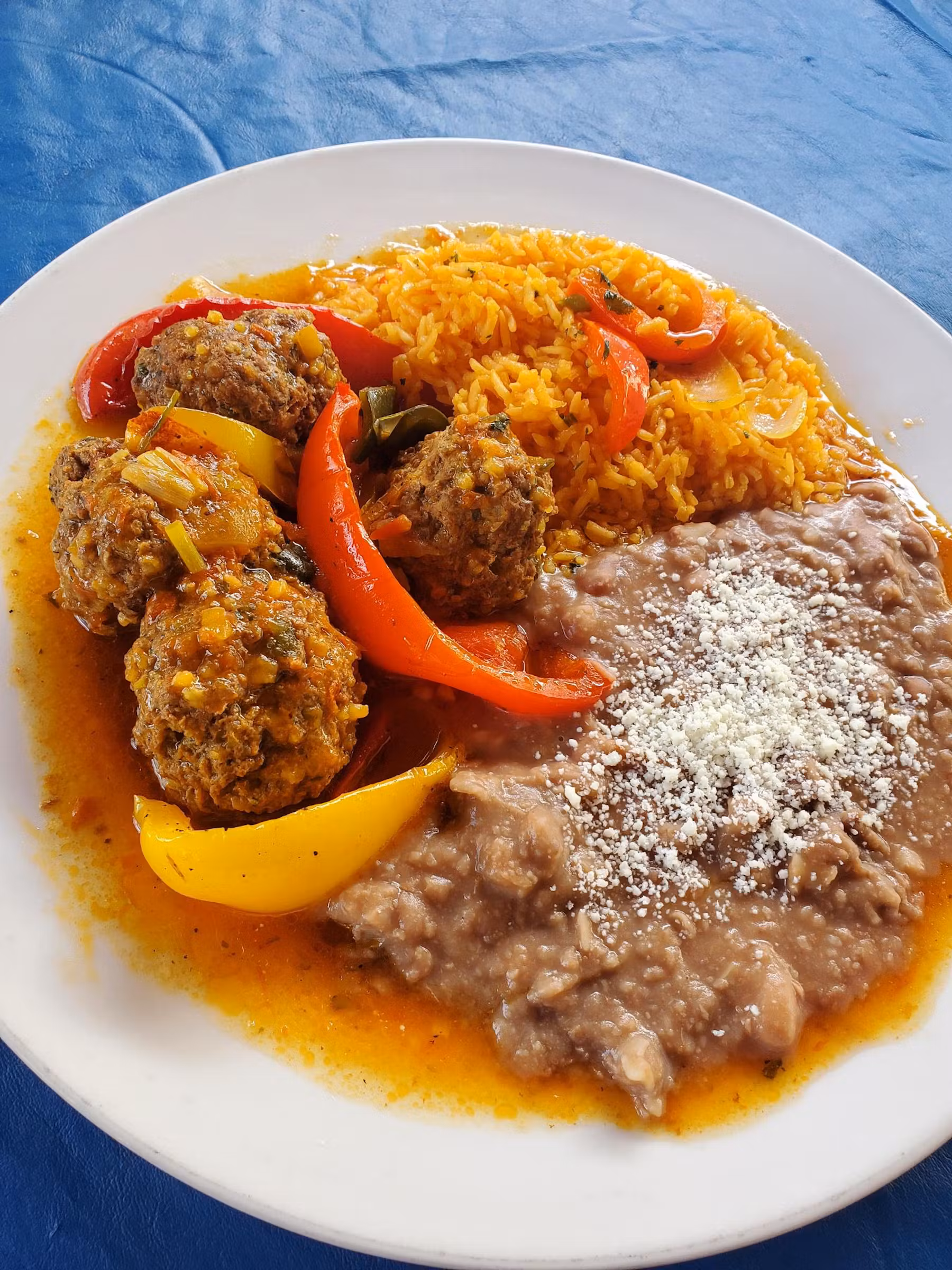 Meatball plate served with rice and beans.