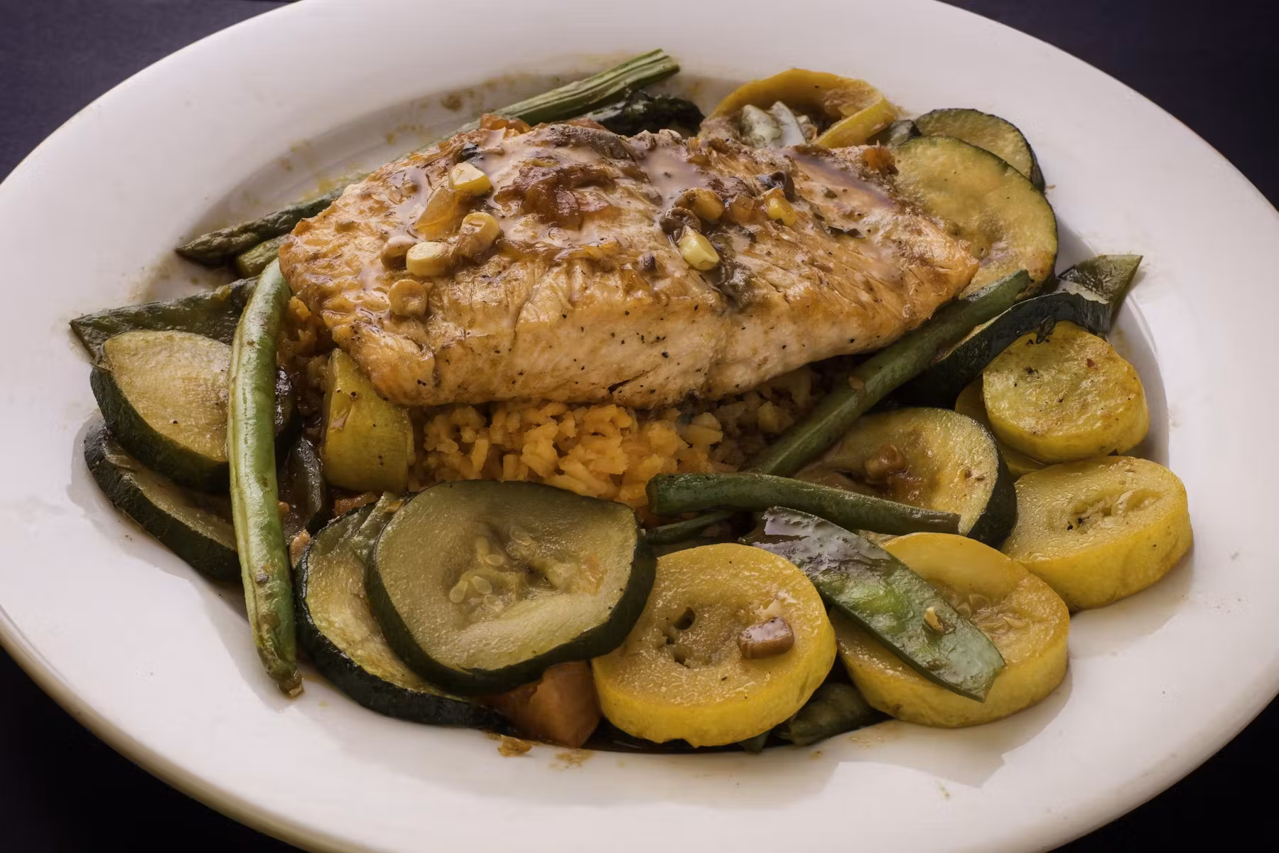 Mexican torta served with an assortment of vegetables.
