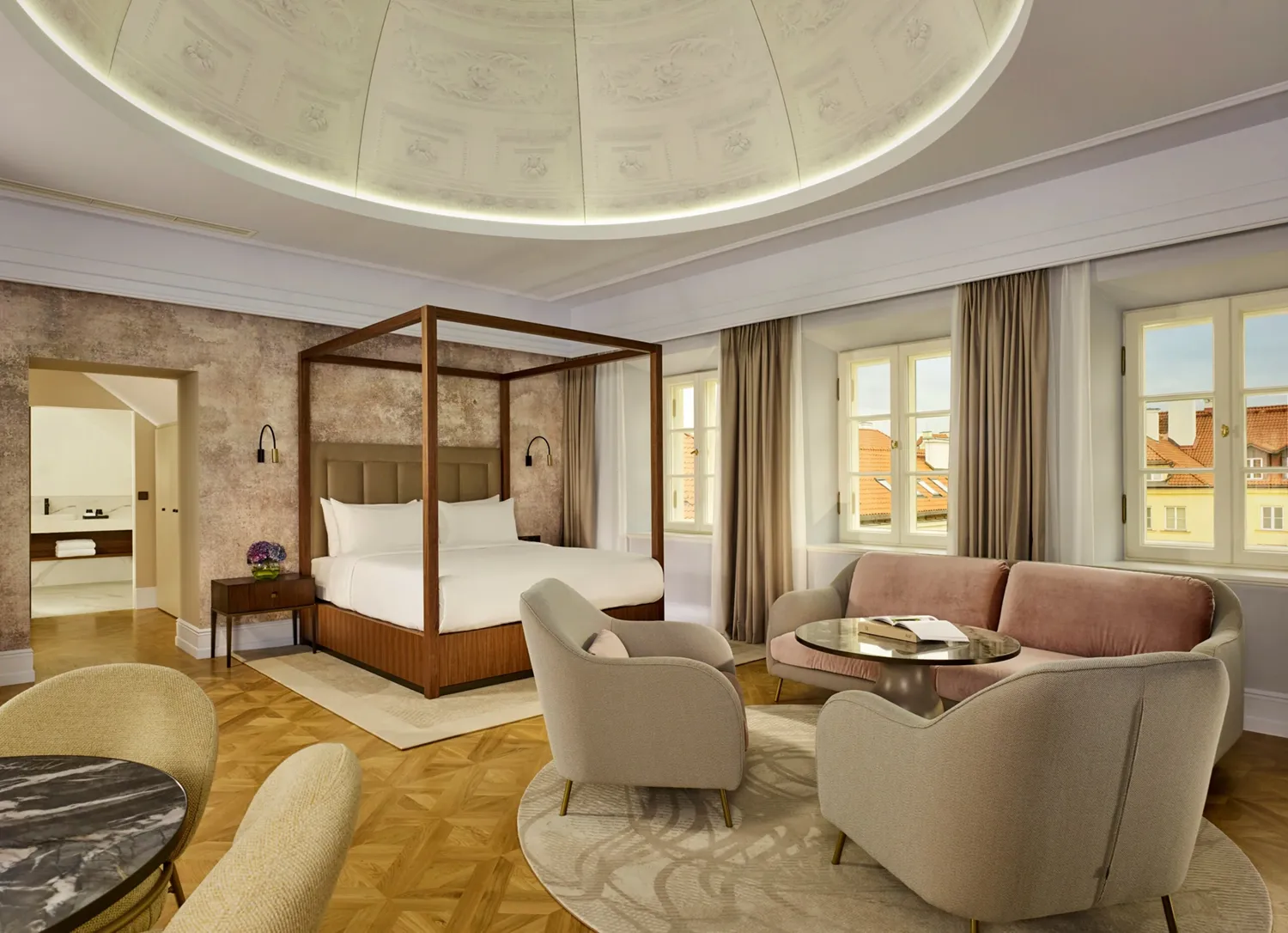 A pyramid stack of empty crystal champagne coupe glasses on a glass table with a dark background and soft lighting.