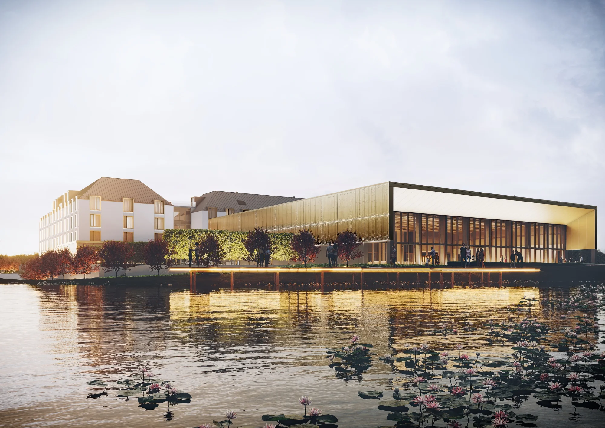 Elegant historical building with large arched windows and a striped tented outdoor seating area, surrounded by greenery and manicured lawns.