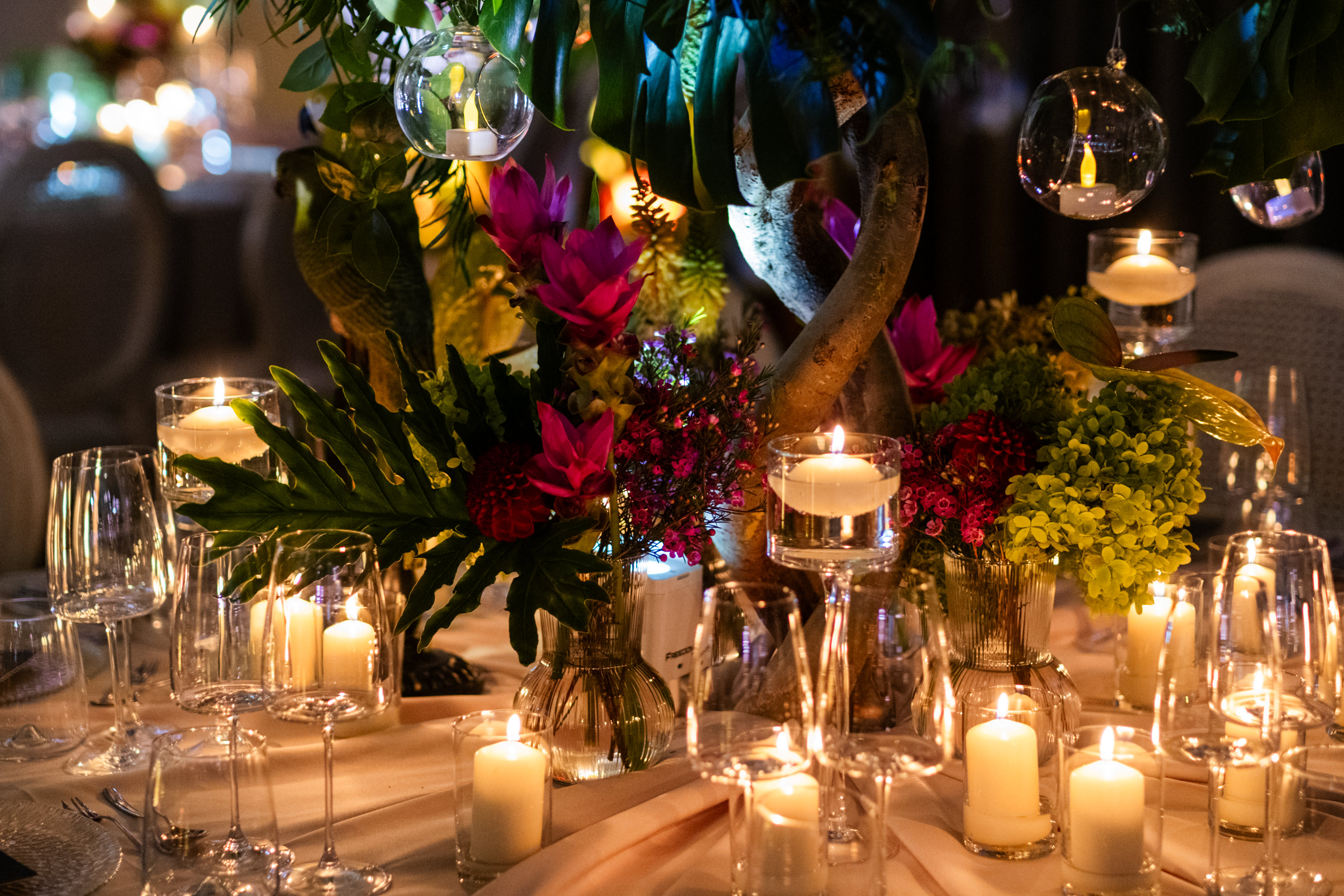 Bride and groom standing at the altar in a church with uniformed guards holding swords forming an arch along the aisle.
