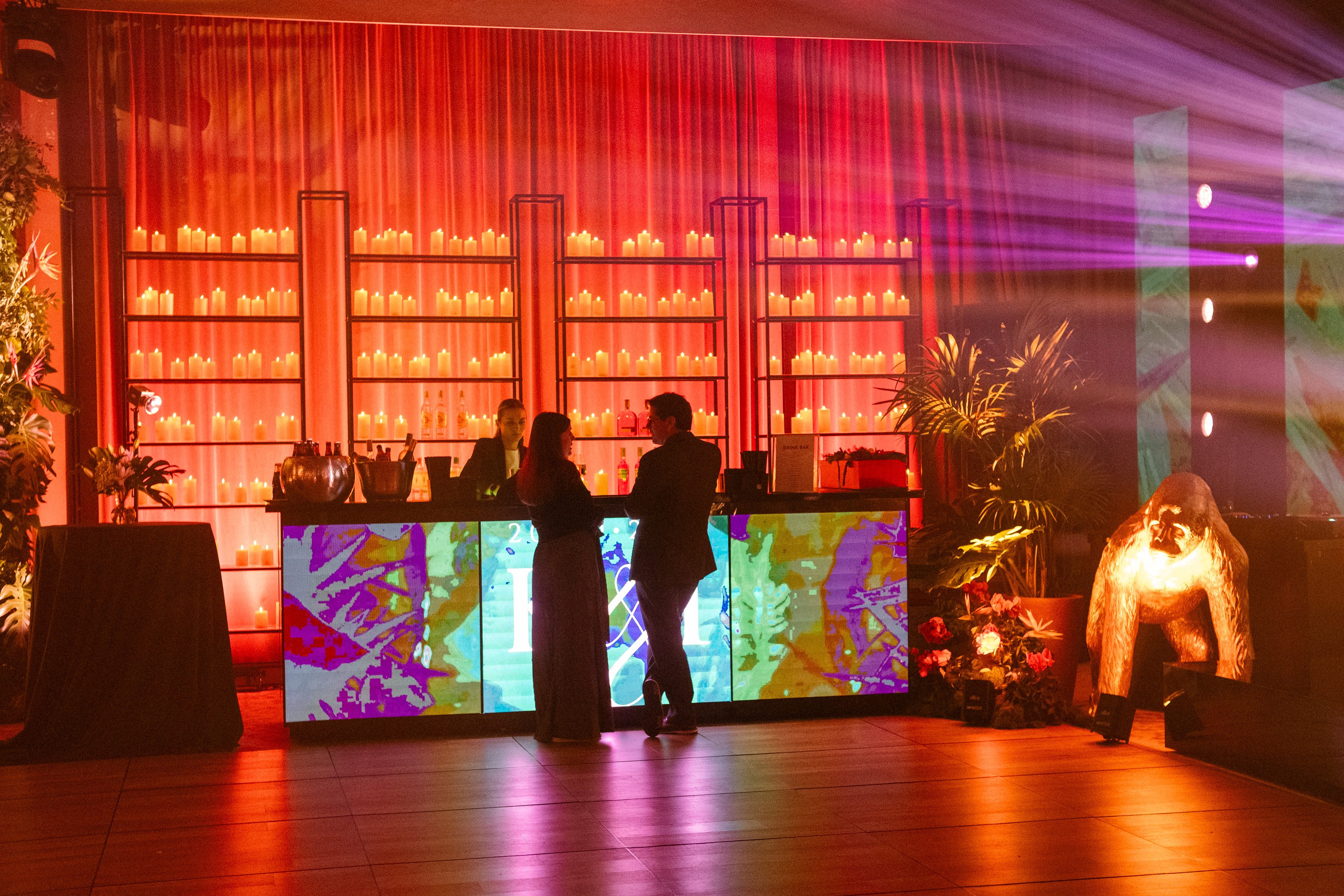 Bride and groom standing at the altar in a church with uniformed guards holding swords forming an arch along the aisle.