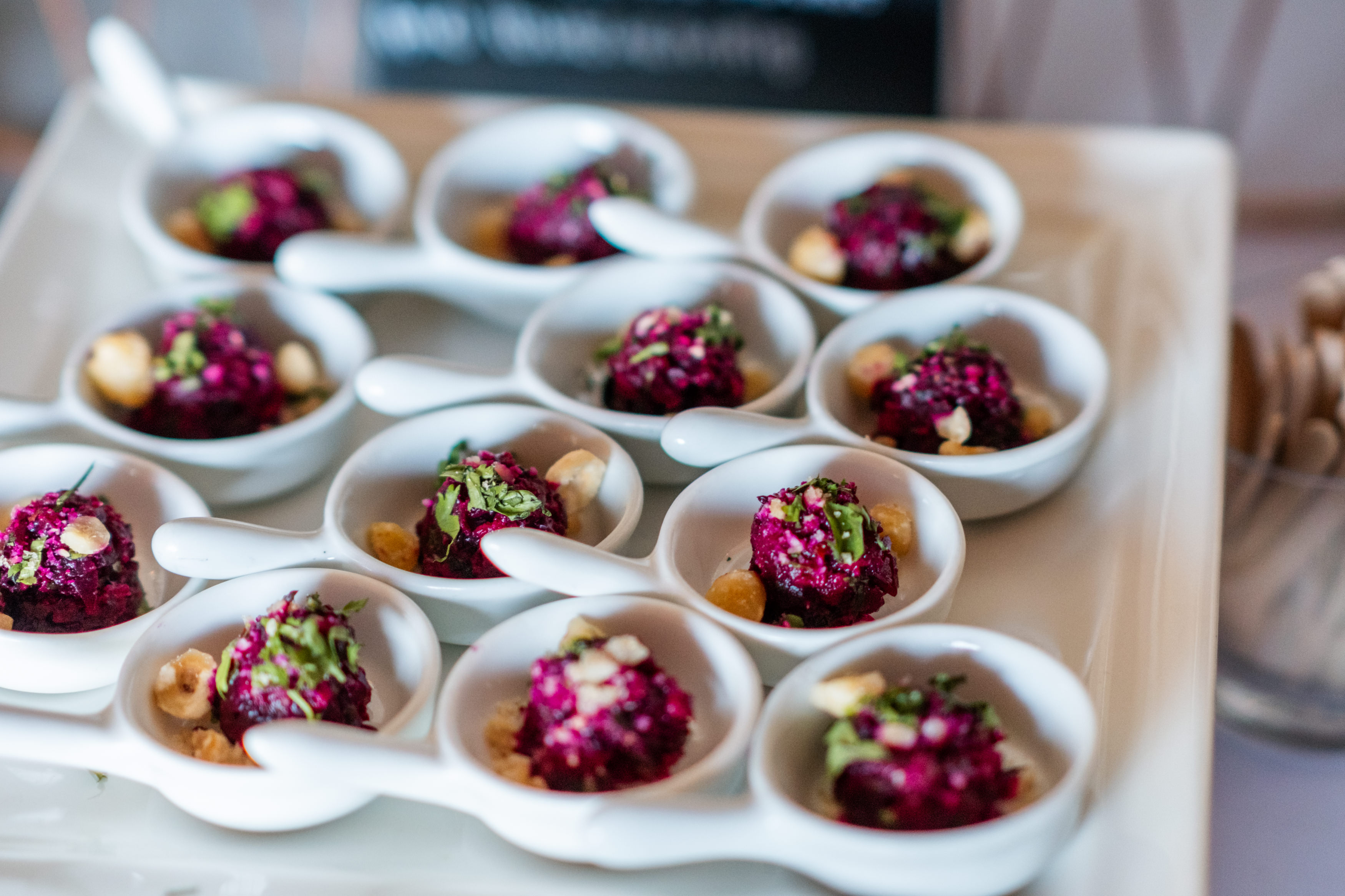 Bride and groom standing at the altar in a church with uniformed guards holding swords forming an arch along the aisle.