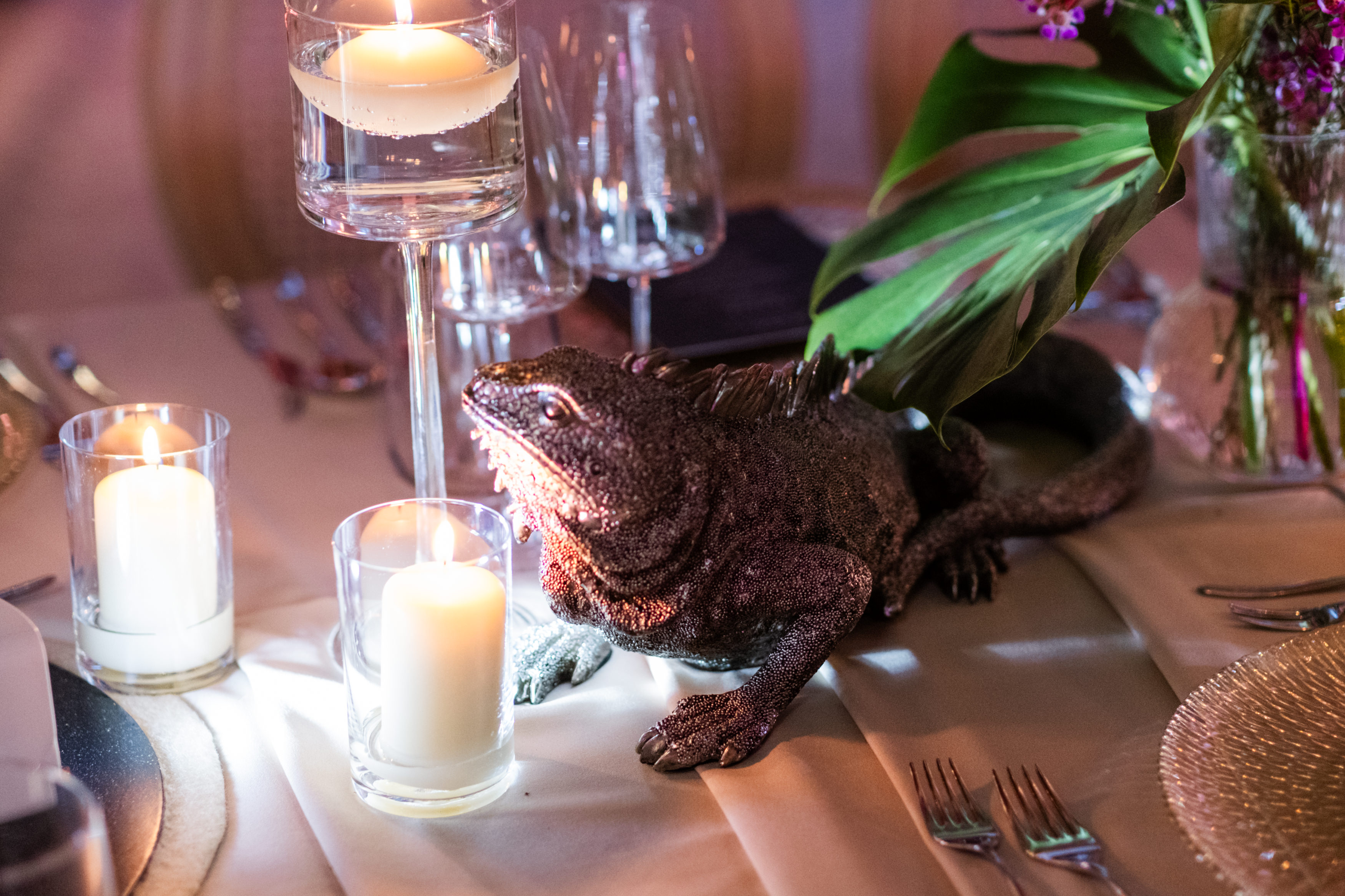 Uniformed men holding swords forming an archway in a decorated church with guests seated on either side.