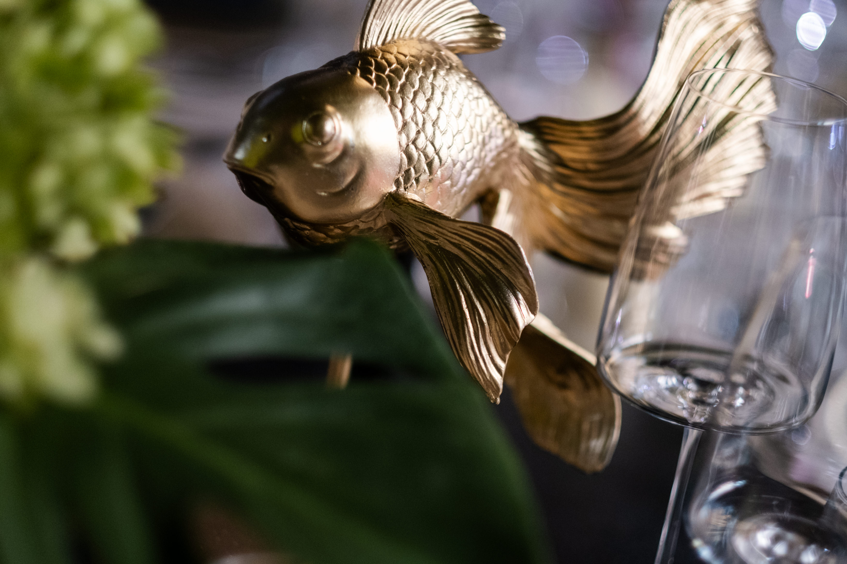 Bride and groom standing at the altar in a church with uniformed guards holding swords forming an arch along the aisle.