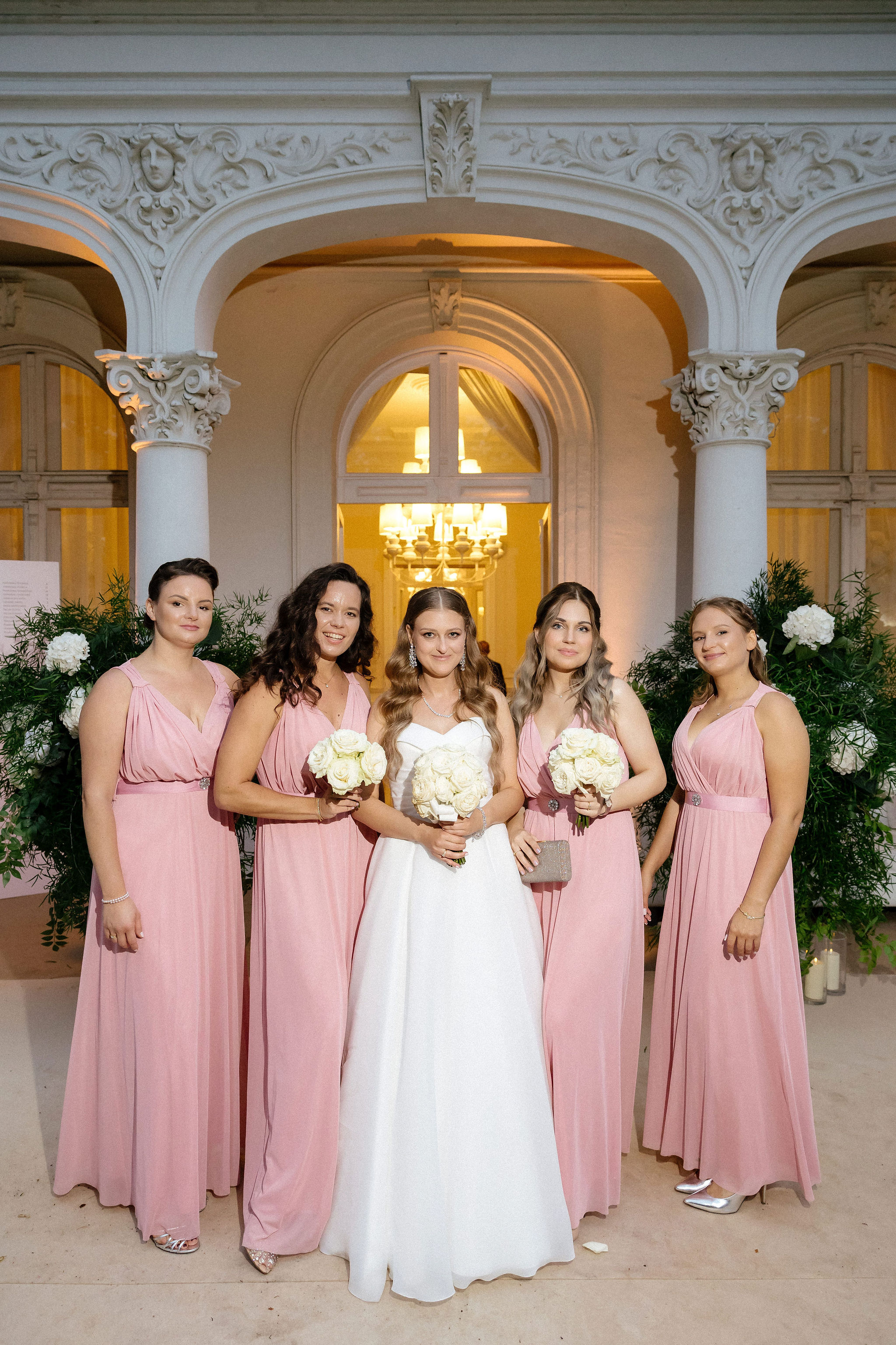 Bride and groom standing at the altar in a church with uniformed guards holding swords forming an arch along the aisle.