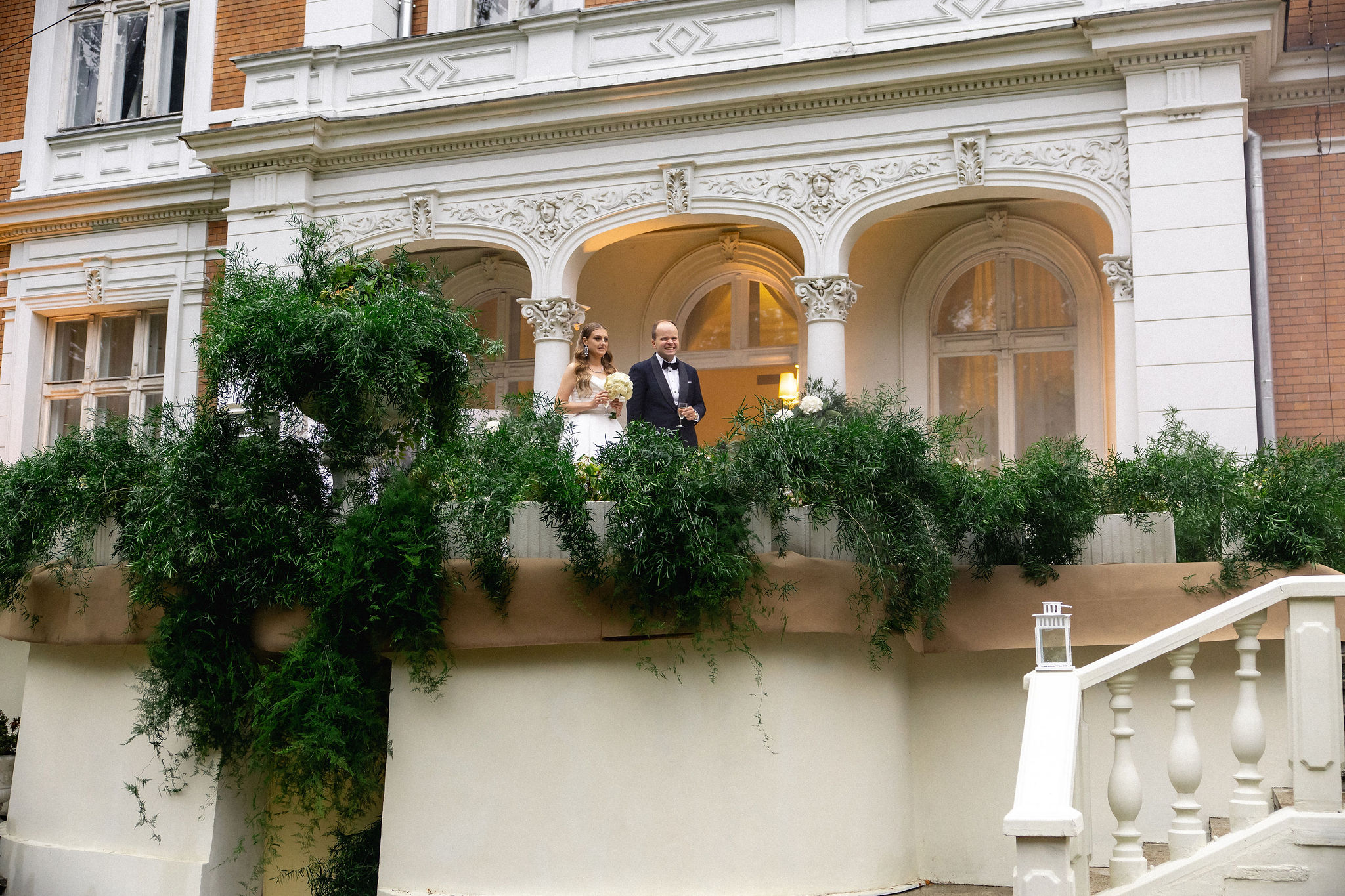 Uniformed men holding swords forming an archway in a decorated church with guests seated on either side.