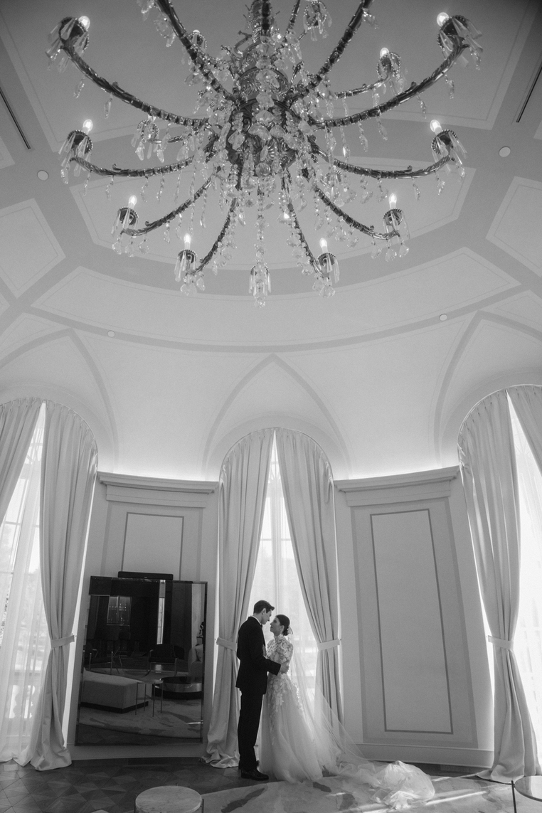 Overhead black and white photo of a crowd dancing at a formal event with a live band performing.