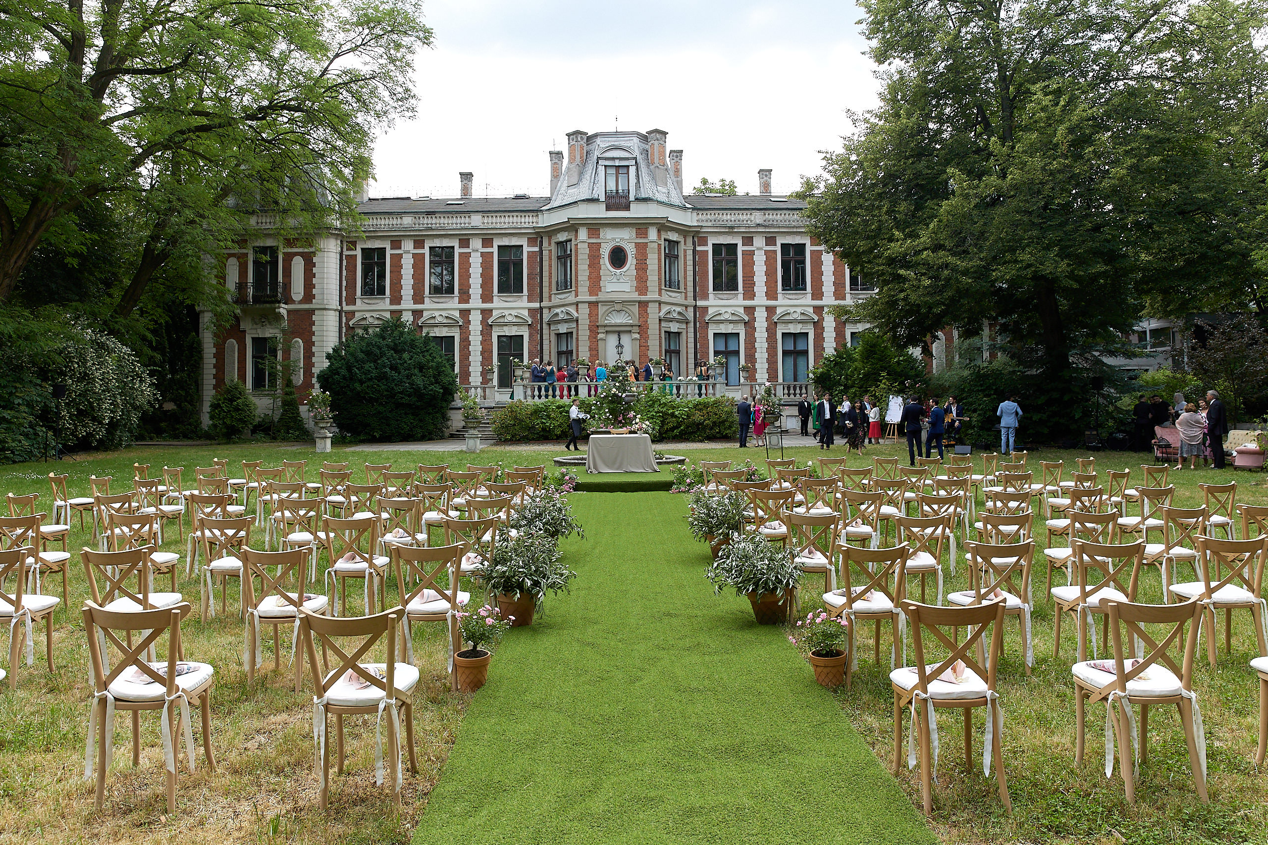 Overhead black and white photo of a crowd dancing at a formal event with a live band performing.