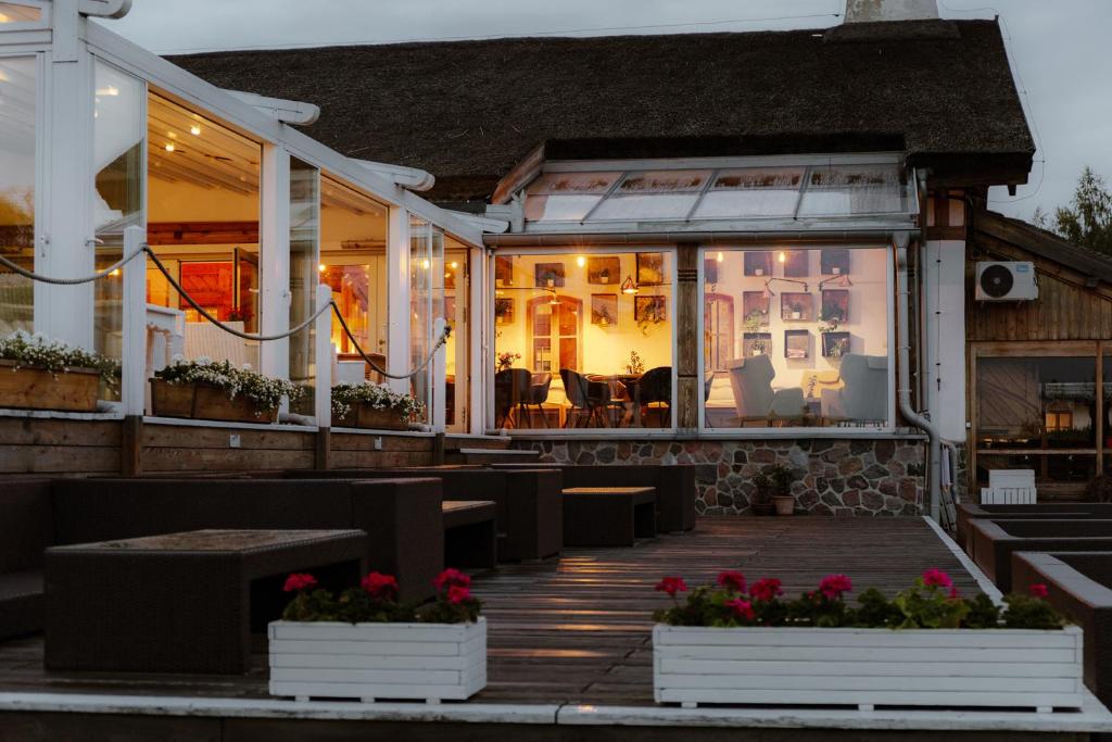 A pyramid stack of empty crystal champagne coupe glasses on a glass table with a dark background and soft lighting.