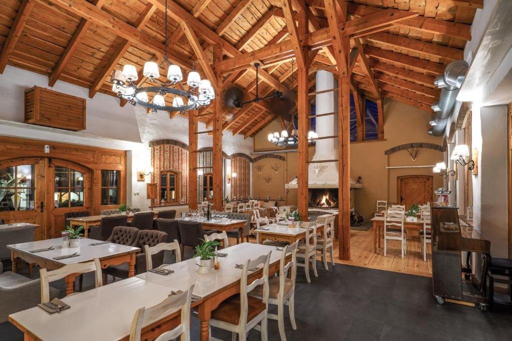 A pyramid stack of empty crystal champagne coupe glasses on a glass table with a dark background and soft lighting.