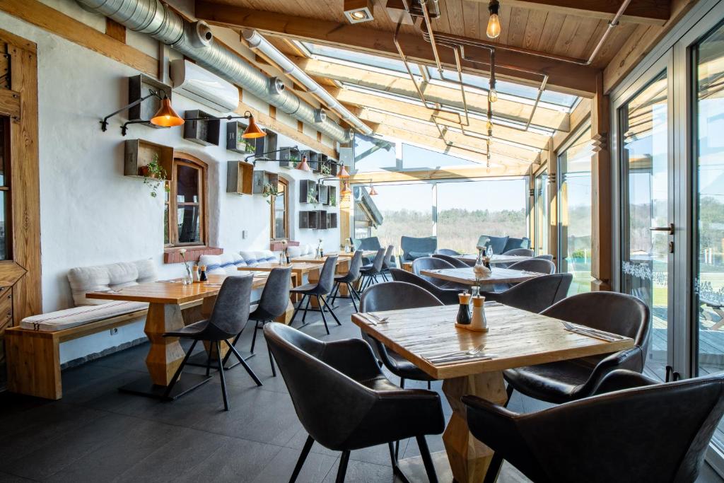 A pyramid stack of empty crystal champagne coupe glasses on a glass table with a dark background and soft lighting.