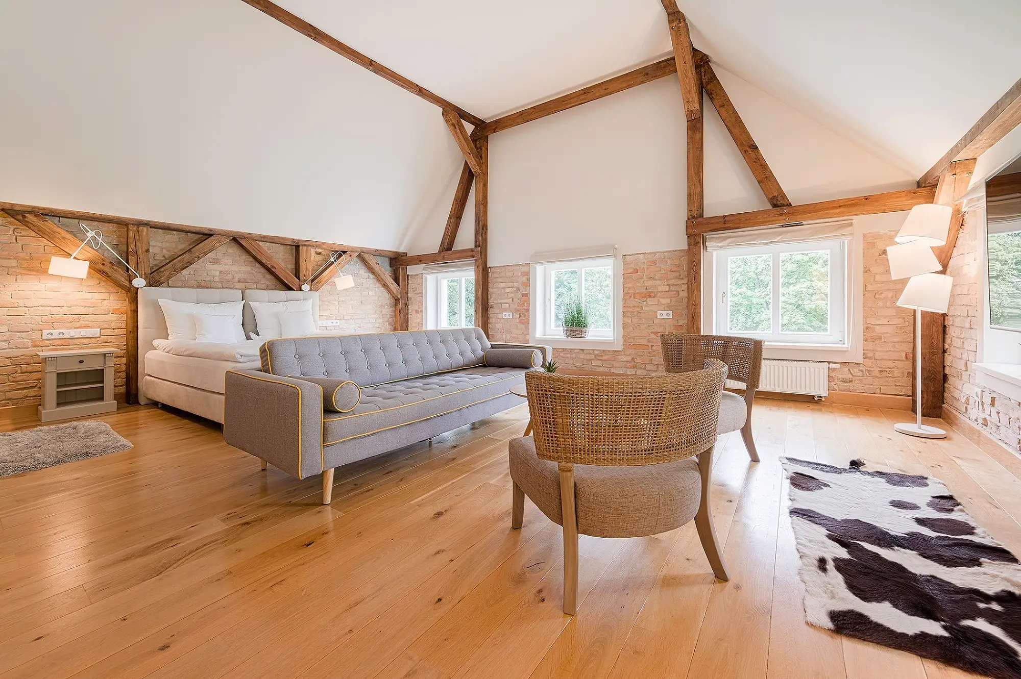 A pyramid stack of empty crystal champagne coupe glasses on a glass table with a dark background and soft lighting.
