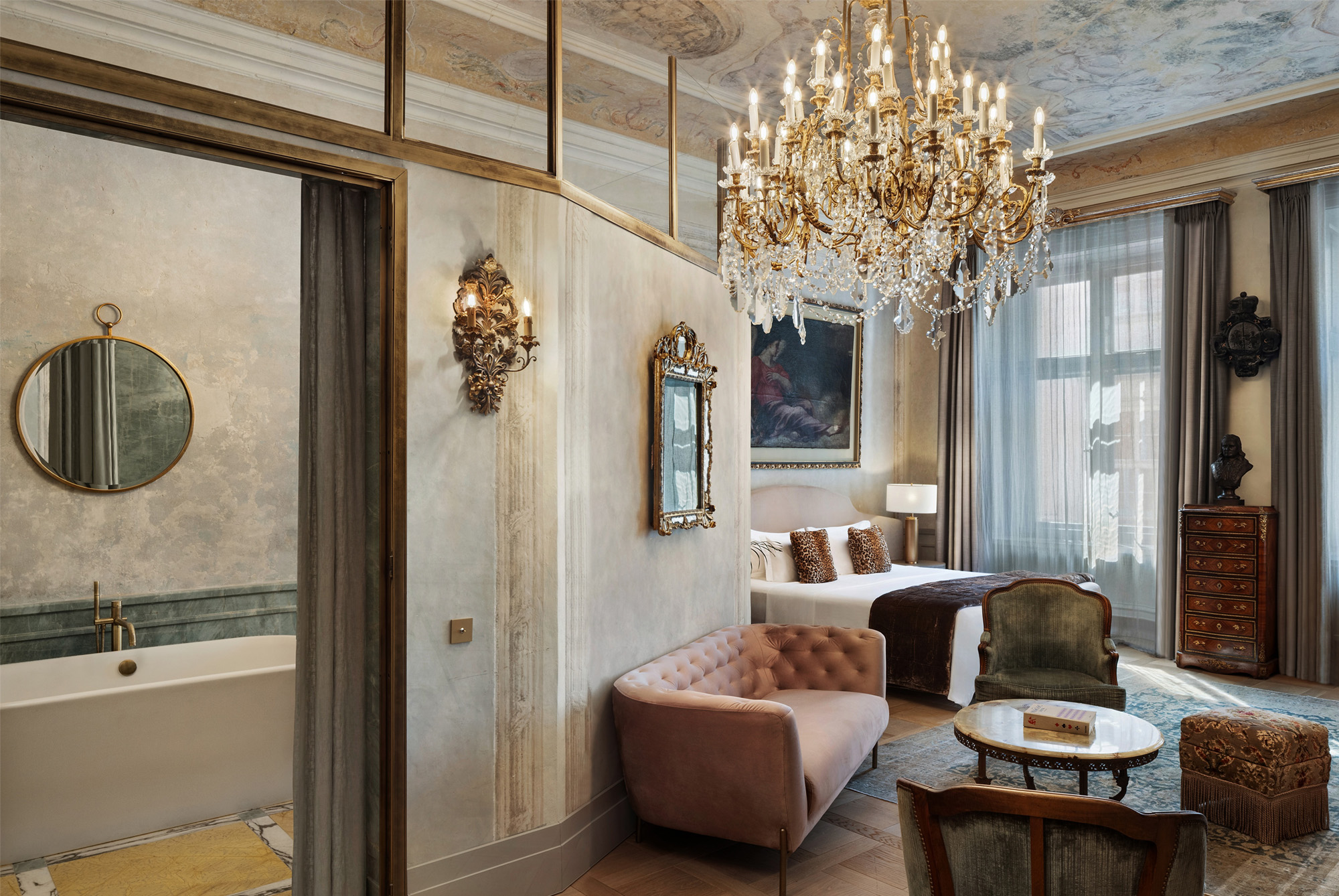 A pyramid stack of empty crystal champagne coupe glasses on a glass table with a dark background and soft lighting.