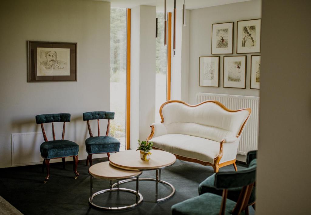 A pyramid stack of empty crystal champagne coupe glasses on a glass table with a dark background and soft lighting.