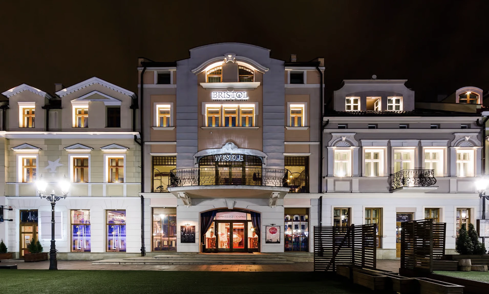 Elegant illuminated Bristol hotel building at night with classic architectural details and outdoor seating area.