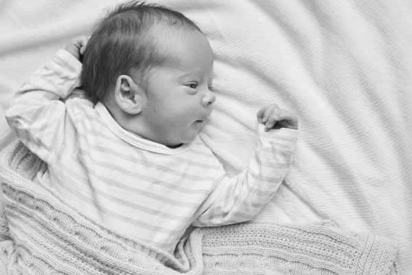 The Baby Consultancy - Newborn Baby lay on back with arms stretched
