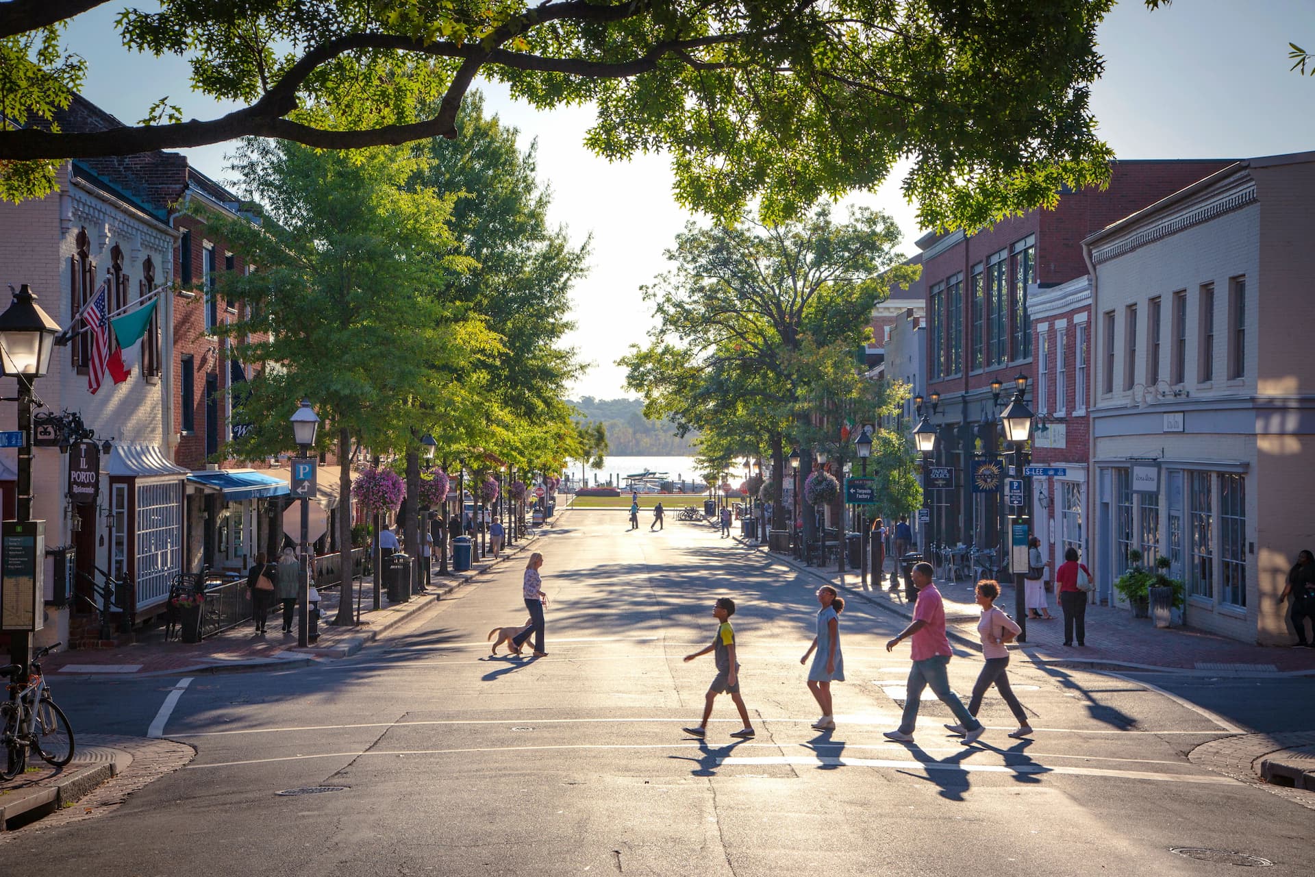 People crossing the street on a nice day.
