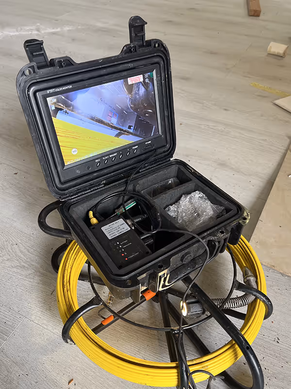 Drain cleaning in progress using professional equipment.