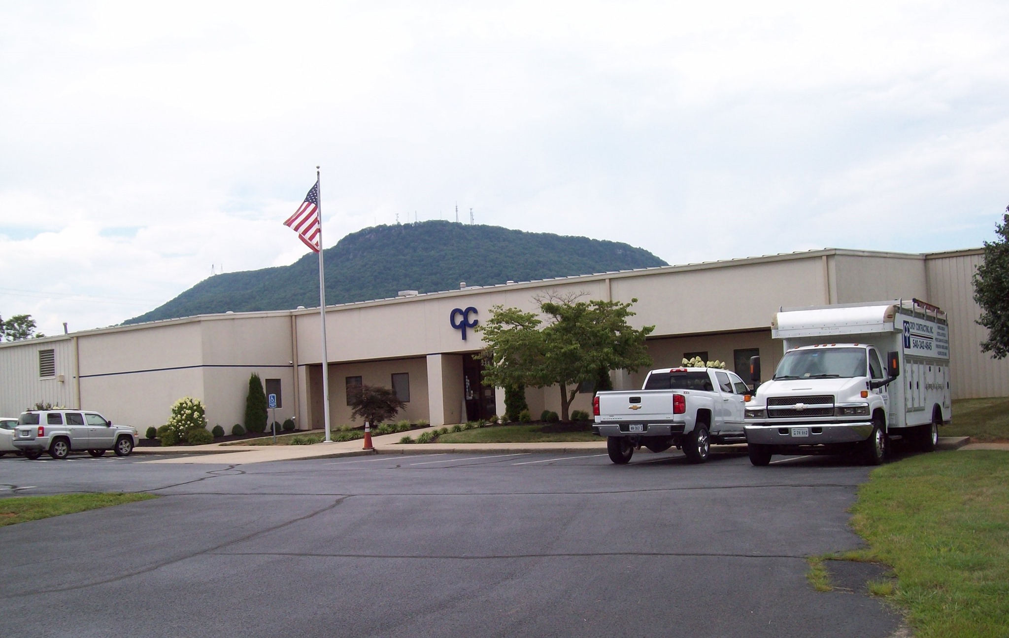 Front of the Croy Contracting building with vehicles and Mill Mountain in the background
