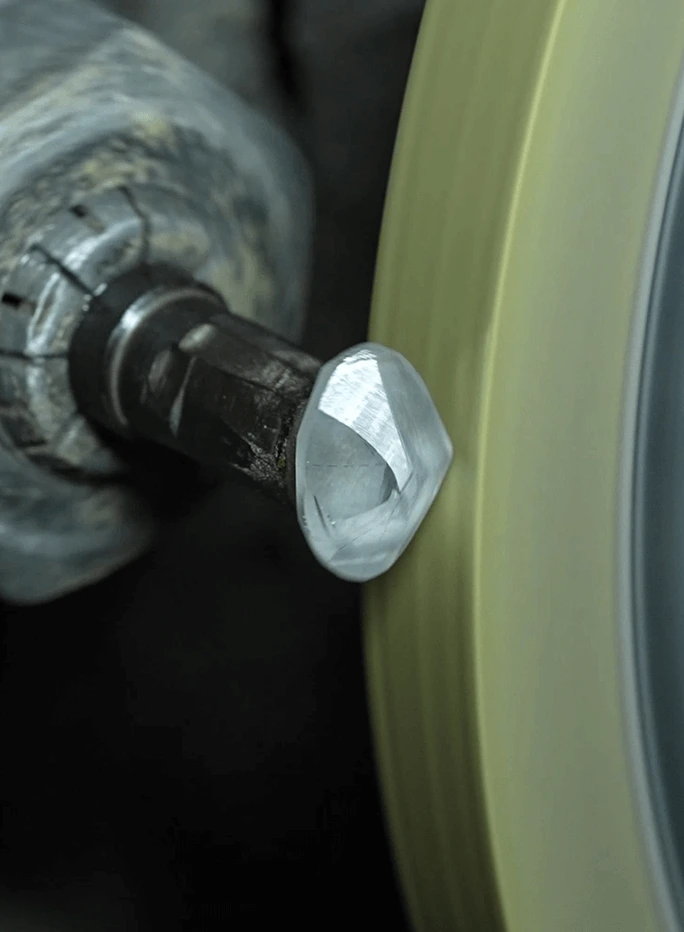 Shaping & polishing a lab diamond on a polishing wheel.