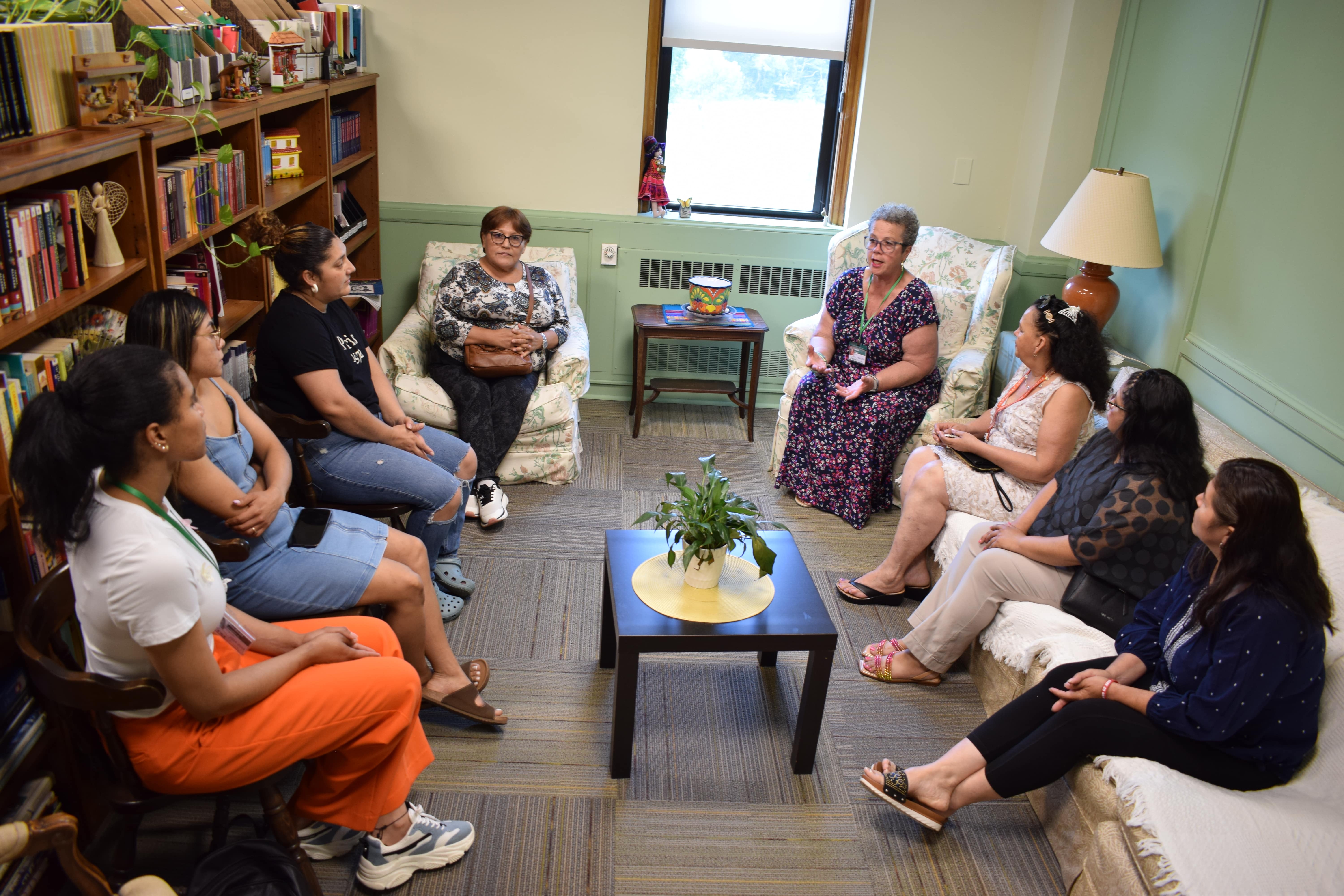The full view of the support box meeting taking place in the library. Yolanda Ortiz is speaking. 