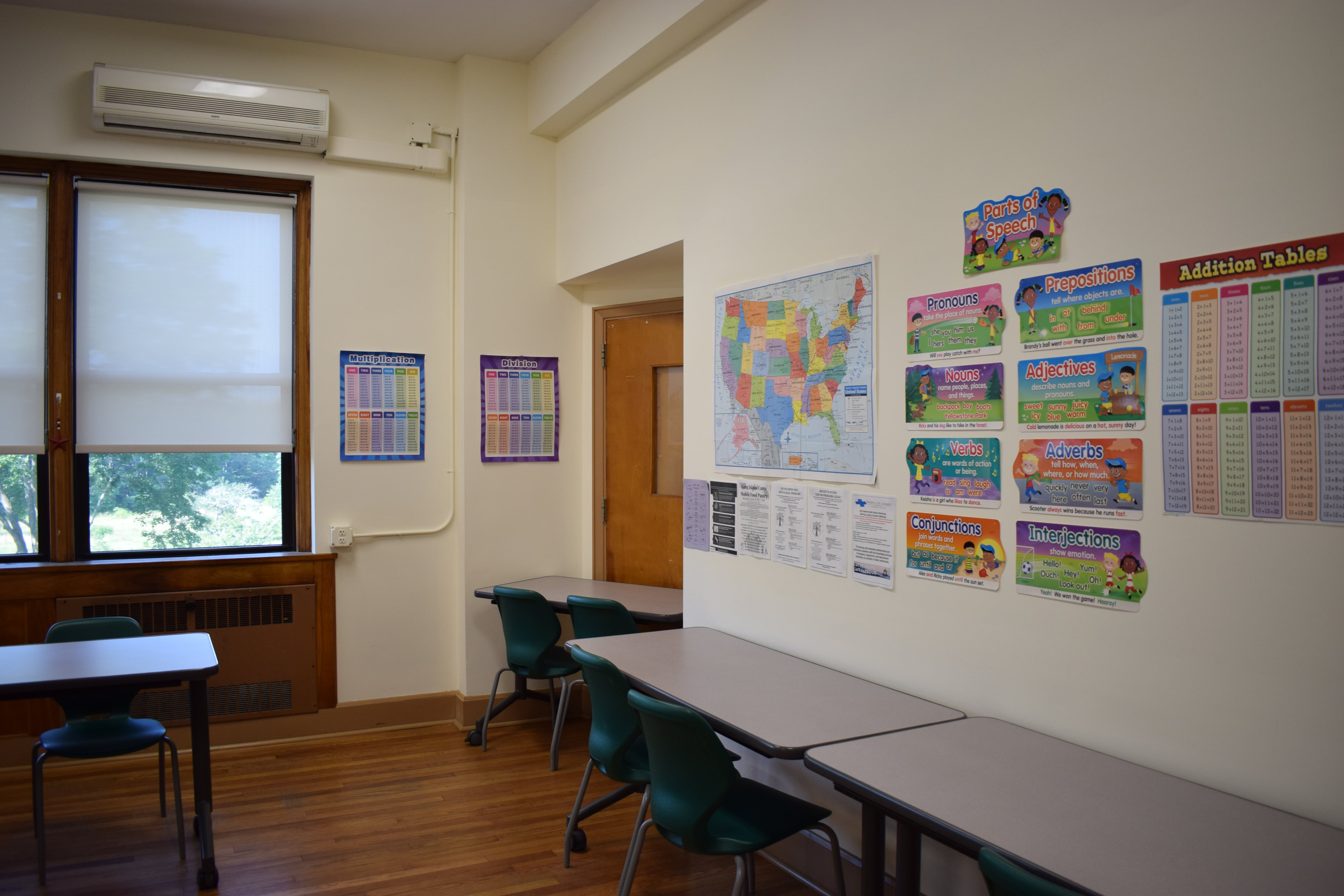 A classroom, desks only, and decorative papers on the wall. 