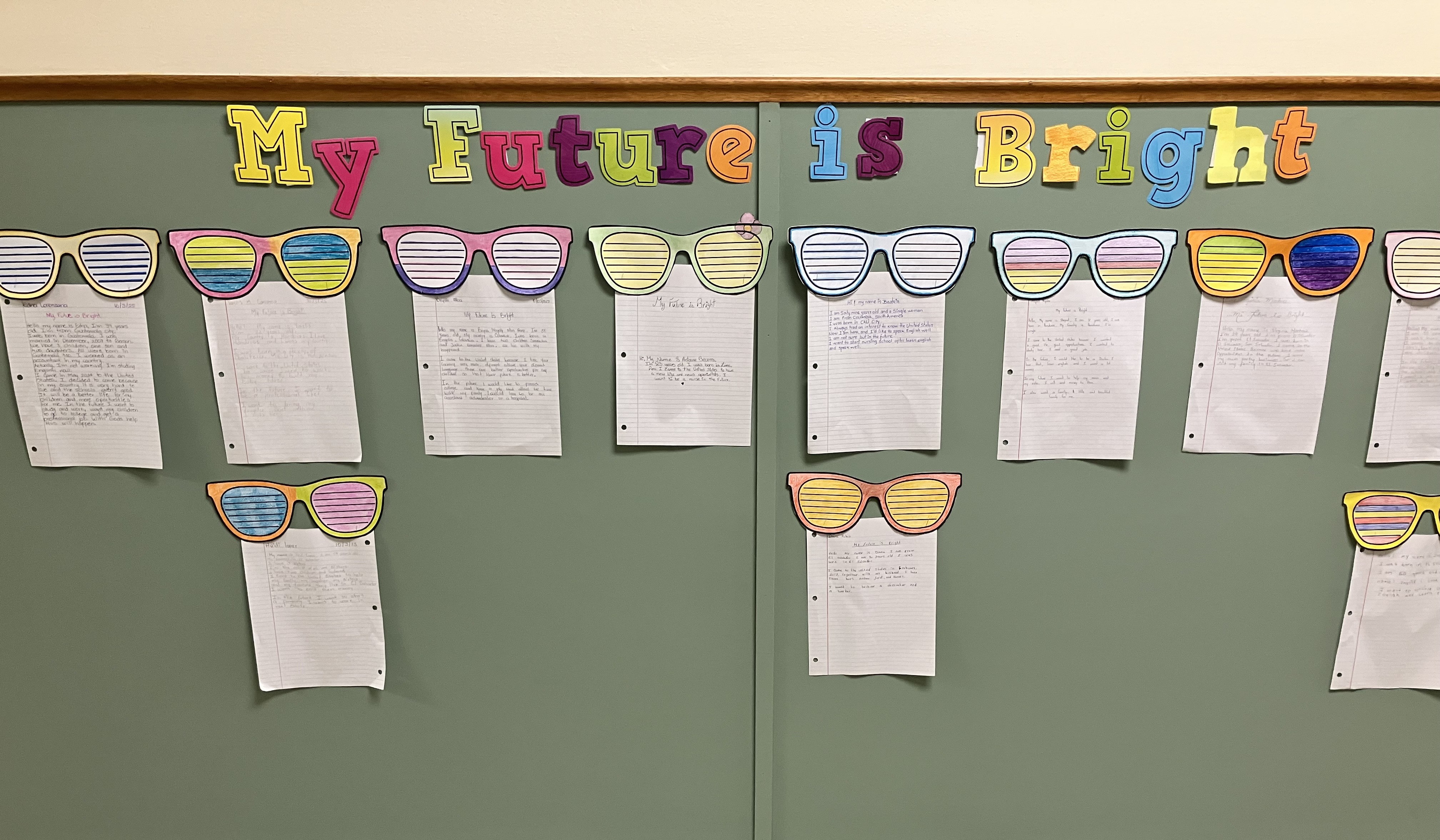 The green board with the paper that was written by the students - their future plans. 