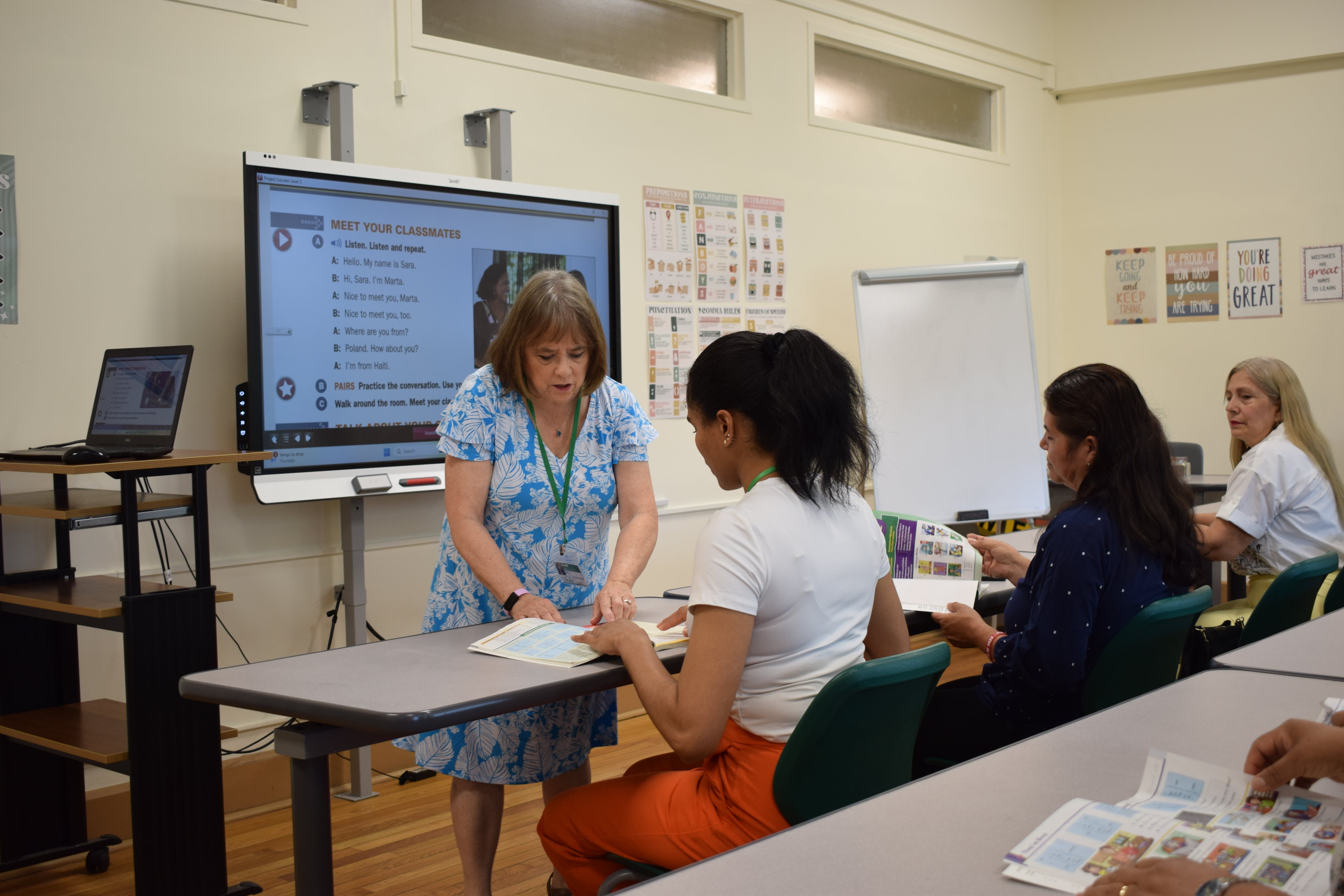 The teacher is explaining to the student a math equation. 