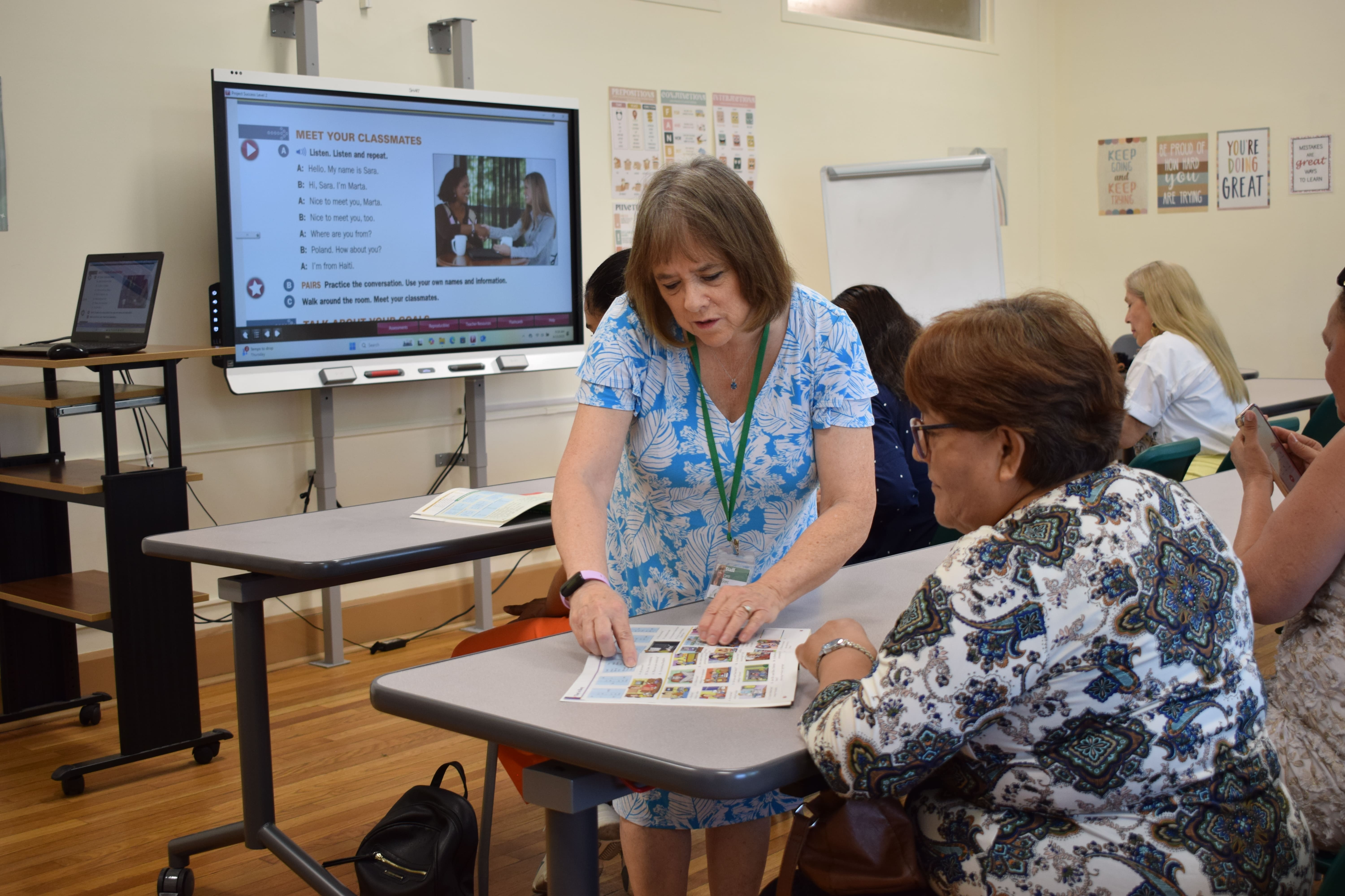 The teacher is reading the English words with the students. 