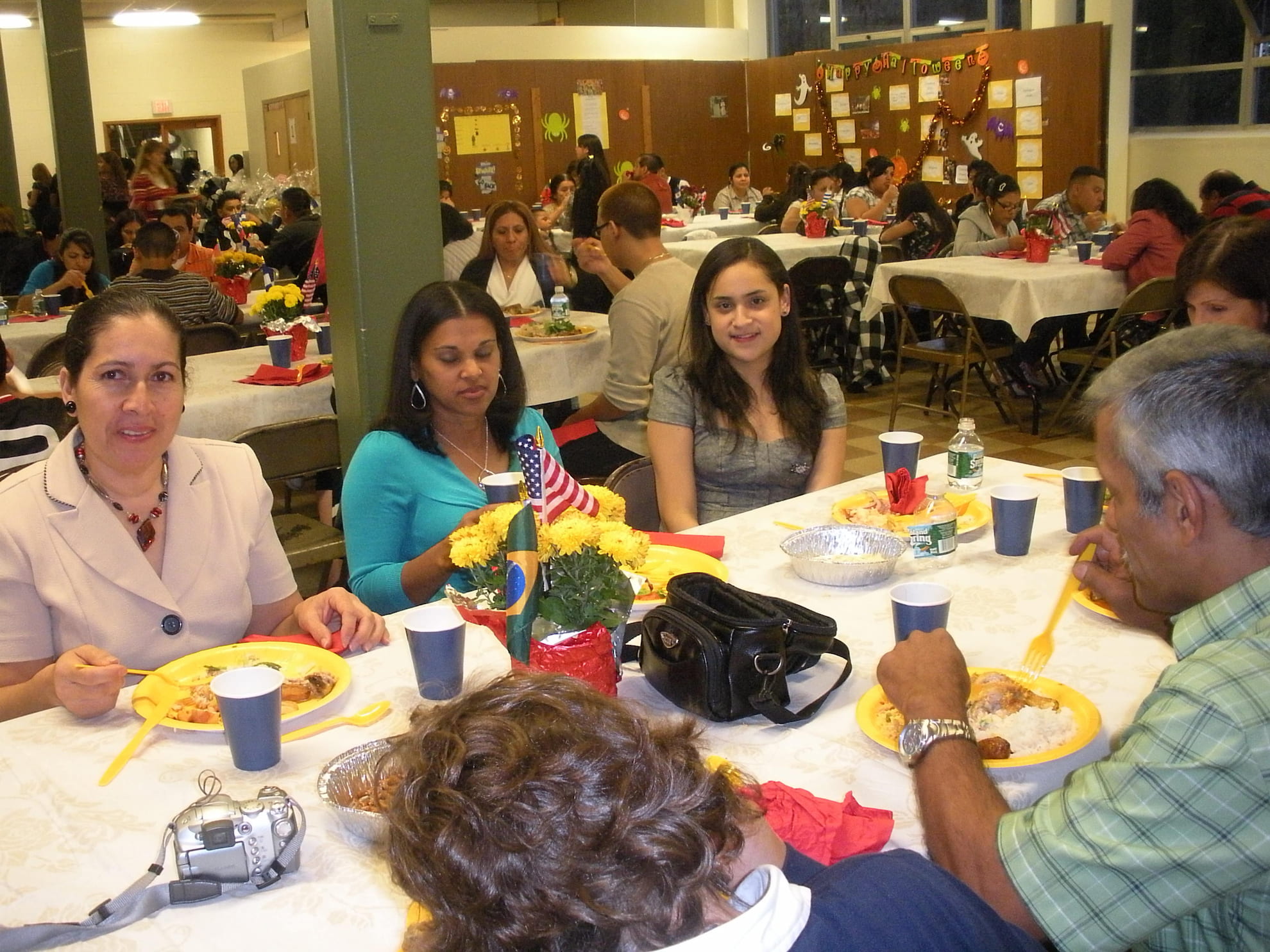Guests seated at tables enjoying dinner during TLC’s 15th anniversary celebration.