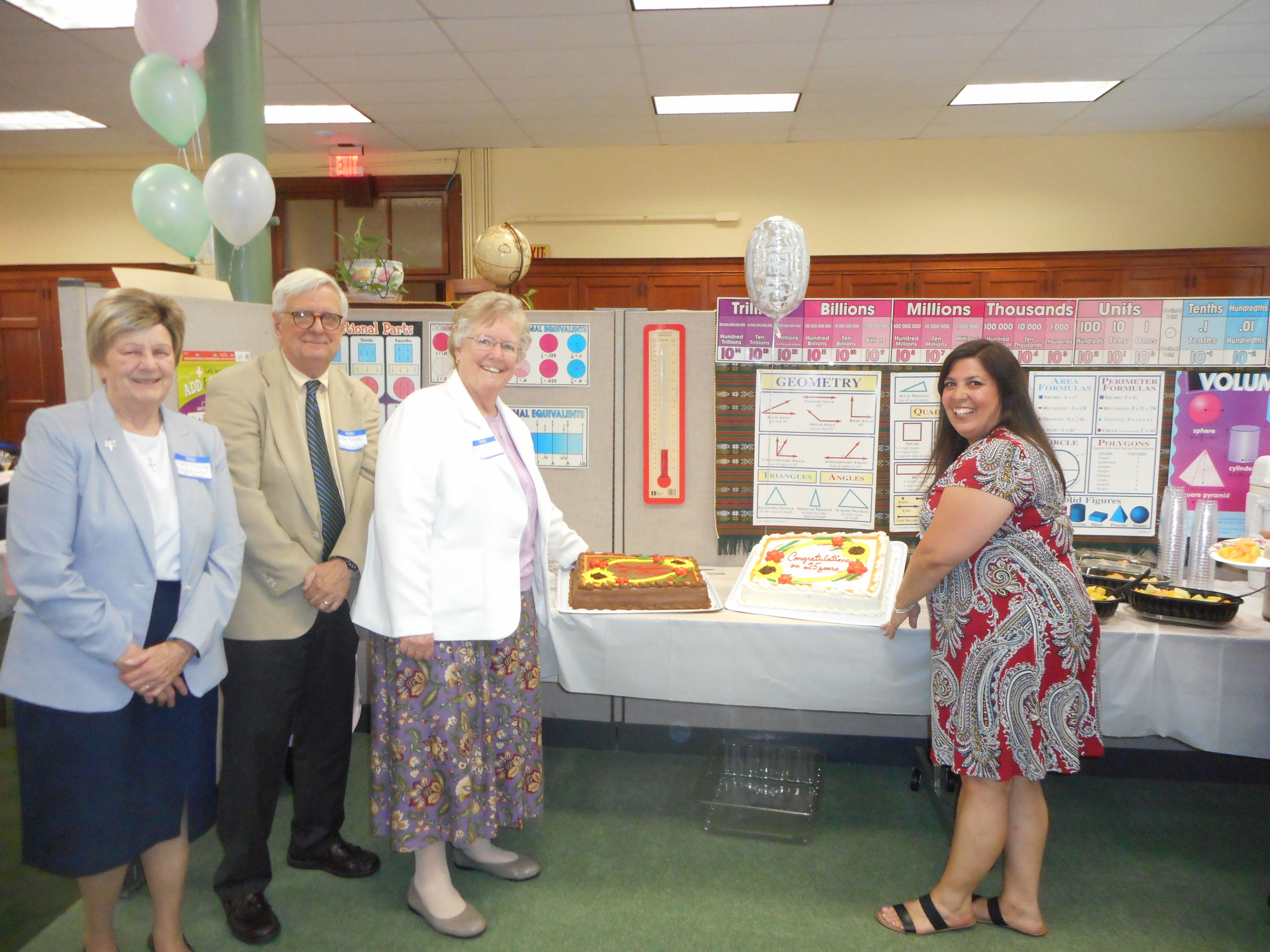 Sister Kathleen Carberry and Denise Murray cutting the cake at TLC’s 25th anniversary celebration, with two guests standing nearby.