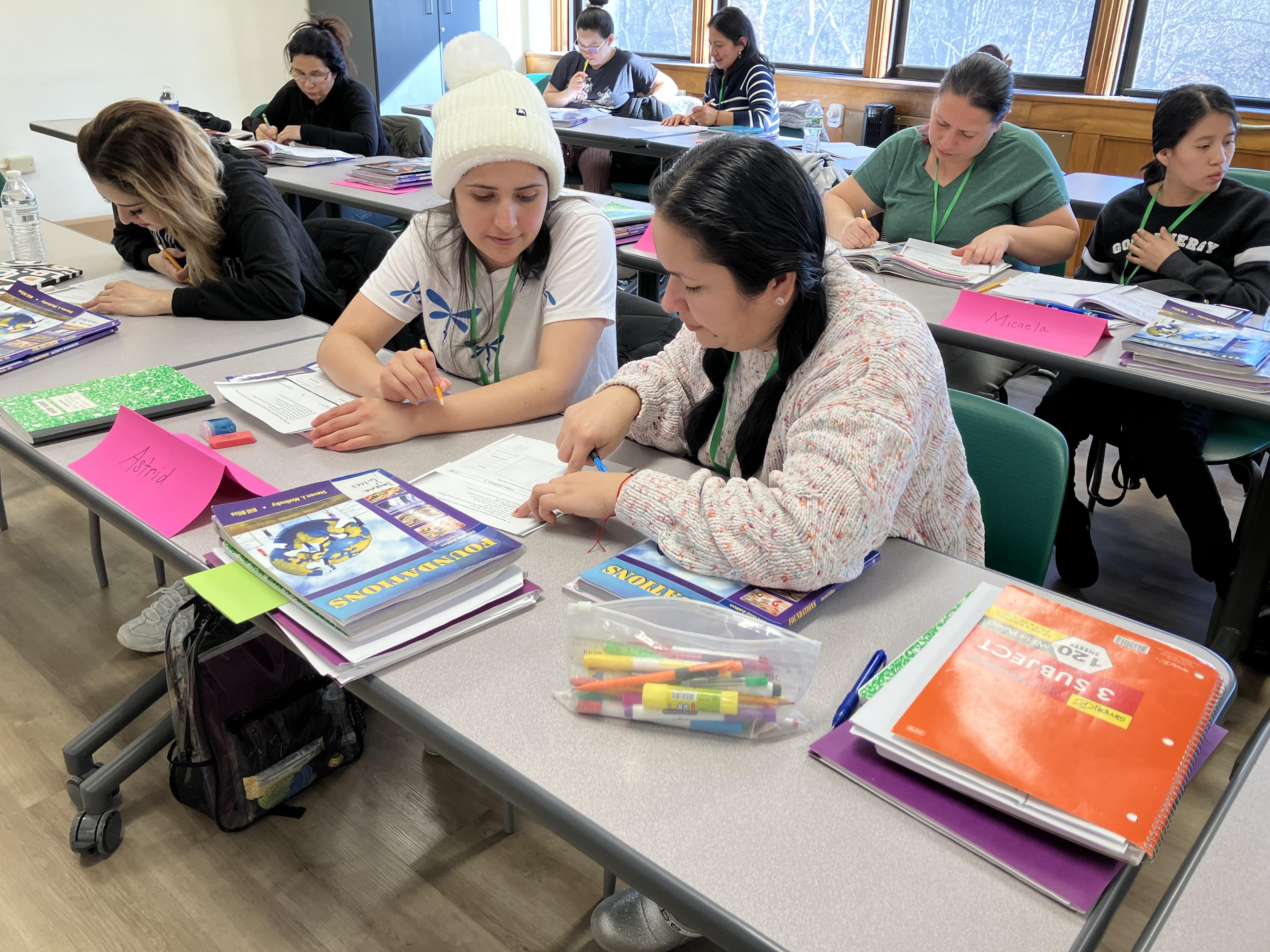 Students in the classroom, helping each other to study. 