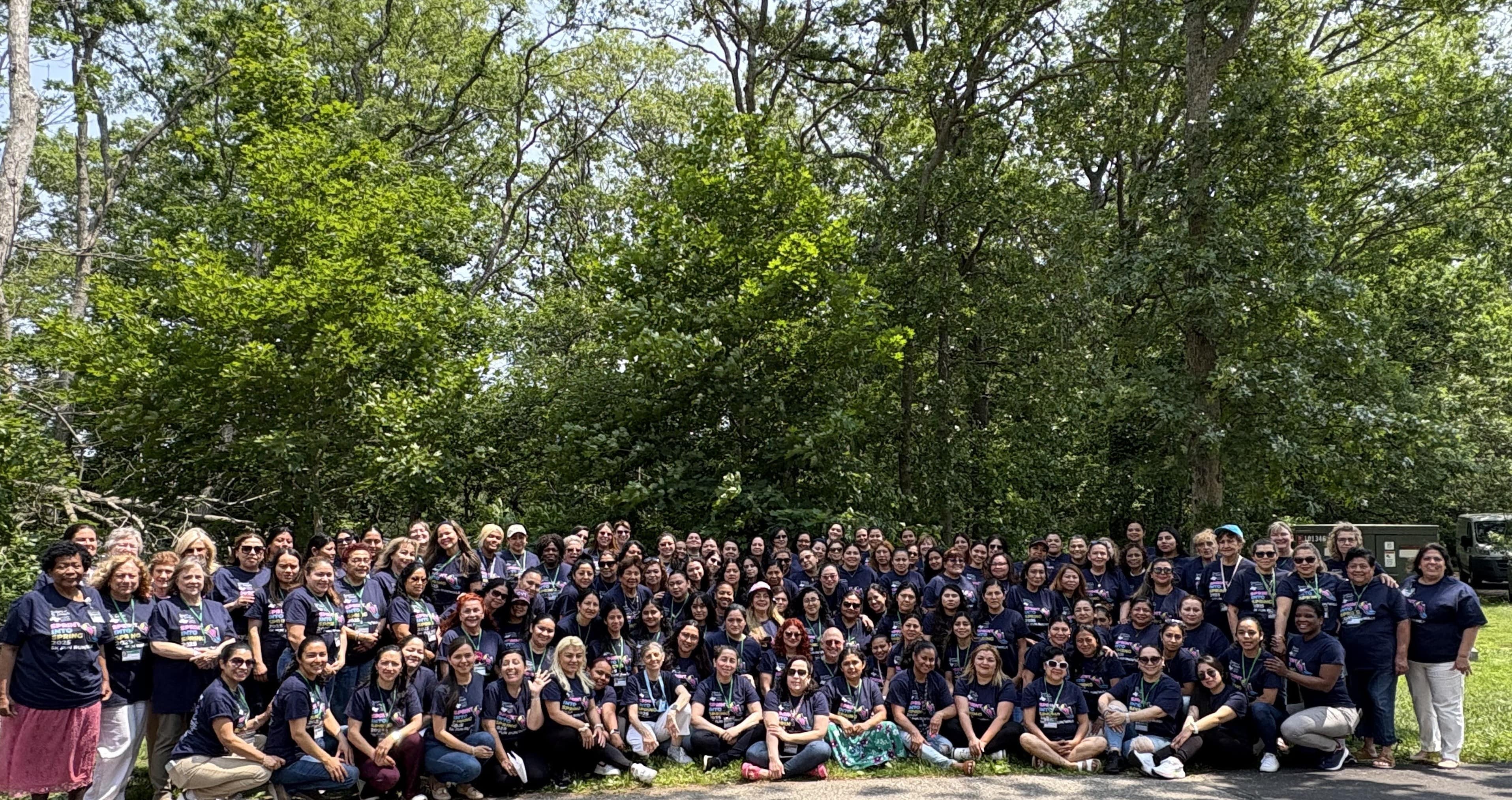 The students are outside - the trees are behind them. The panorama photo. 