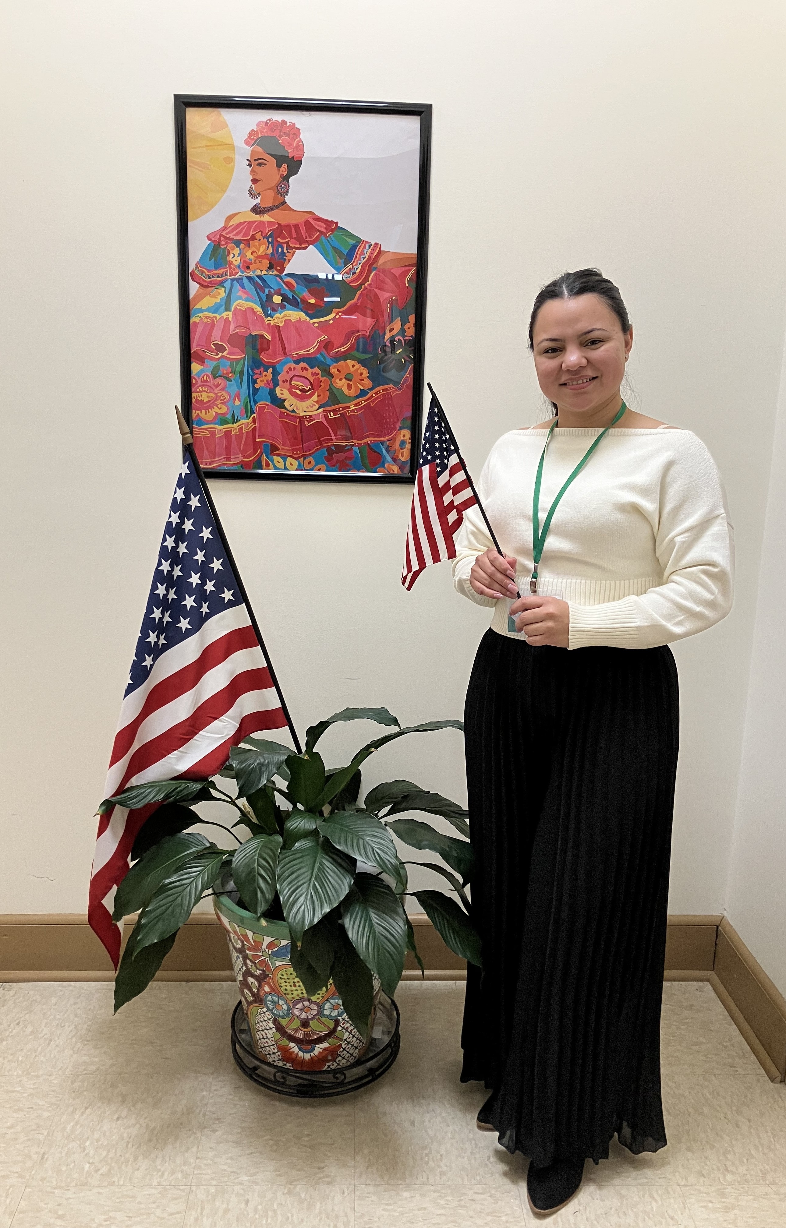 A TLC student holding her certificate of citizenship.