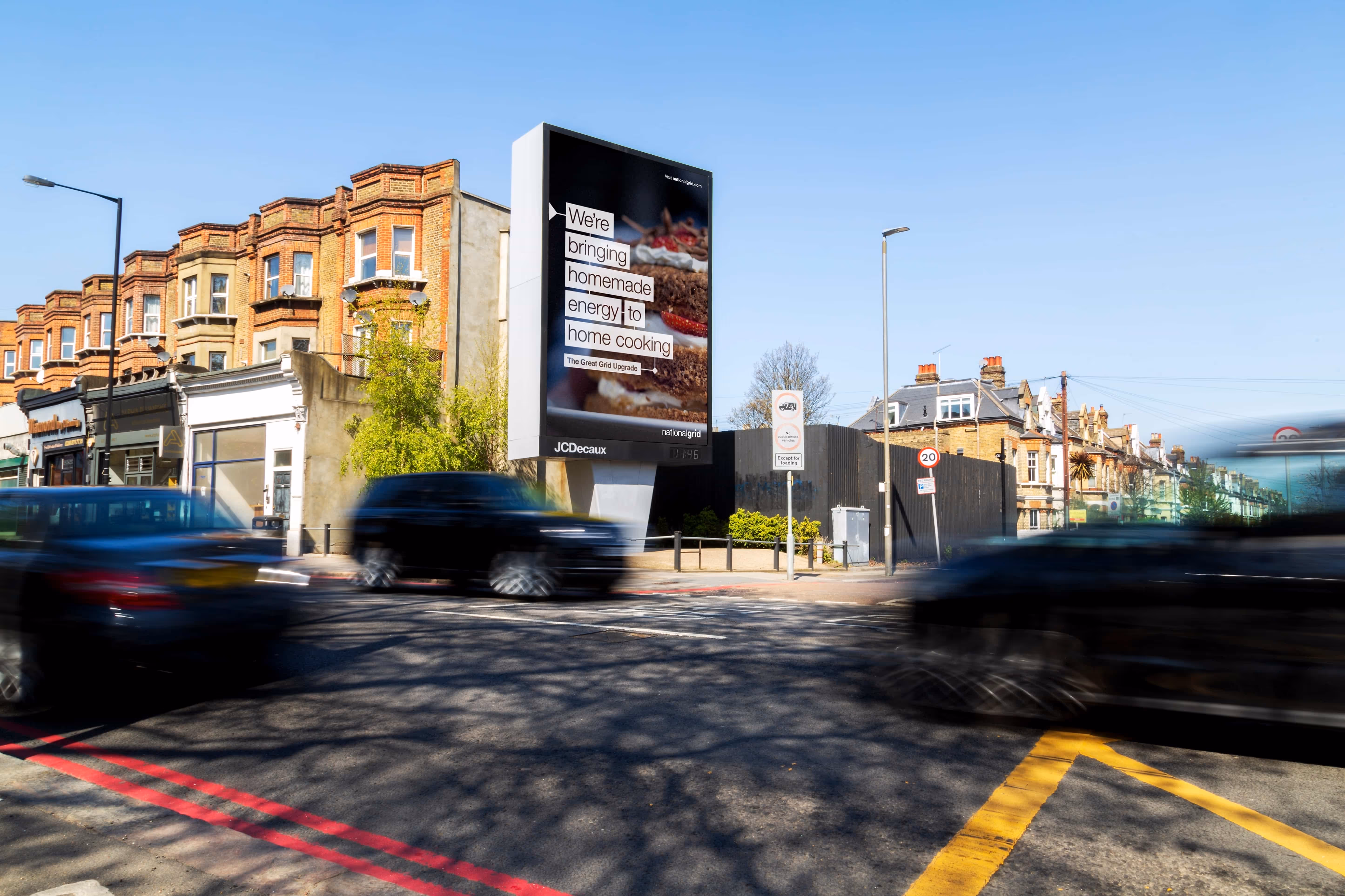 Digital billboard advertising homemade energy near blurry street with cars