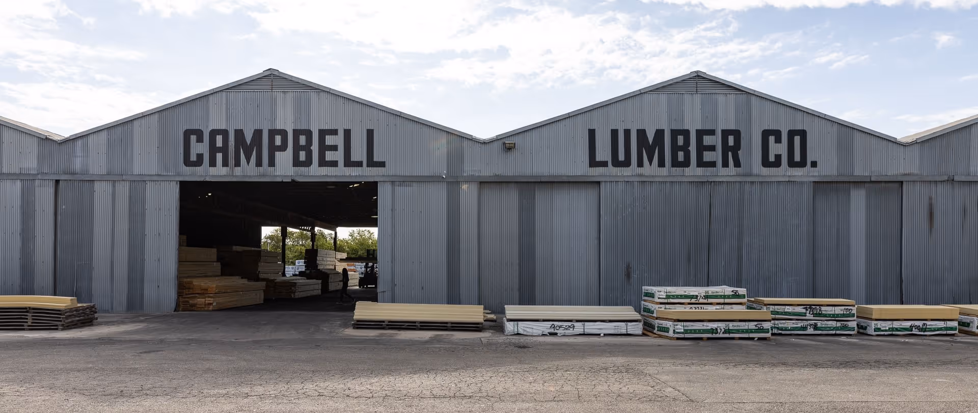 Campbell Lumber Co. warehouse with stacked wooden boards outside