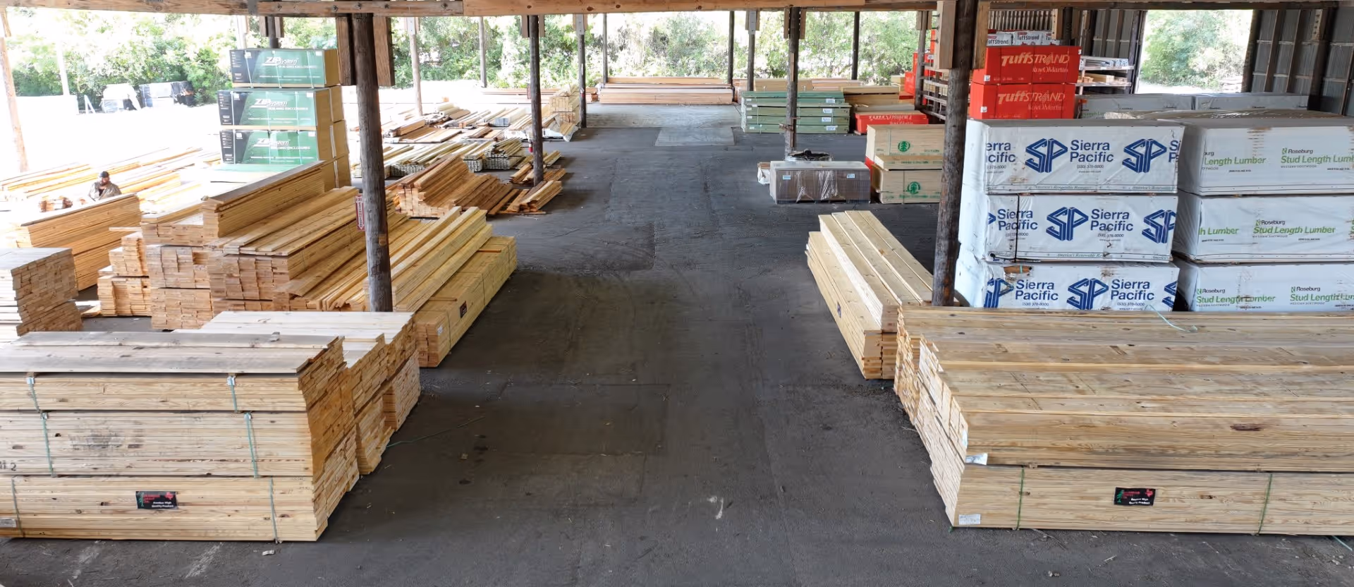 Lumber warehouse with stacked wood planks and Sierra Pacific boxes