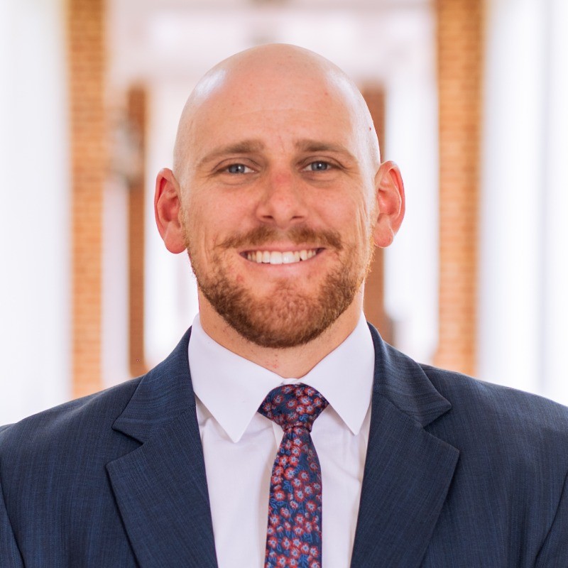 Professional headshot of Ed Kelly, M7A MBA admissions consulting client in business suit