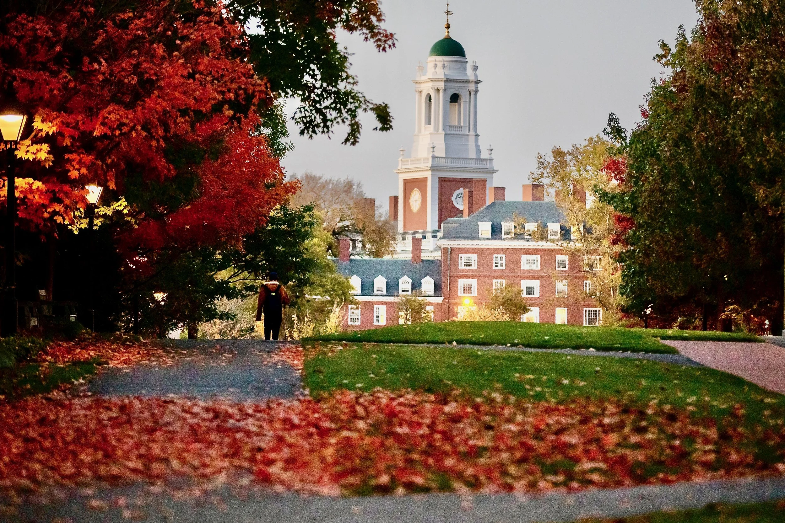 Harvard Business School campus in autumn with iconic bell tower and red foliage