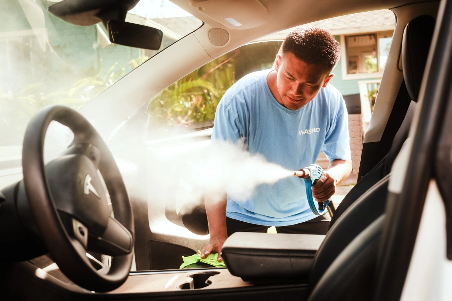 WASHD technician performing mobile steam detailing for a business fleet in Oʻahu