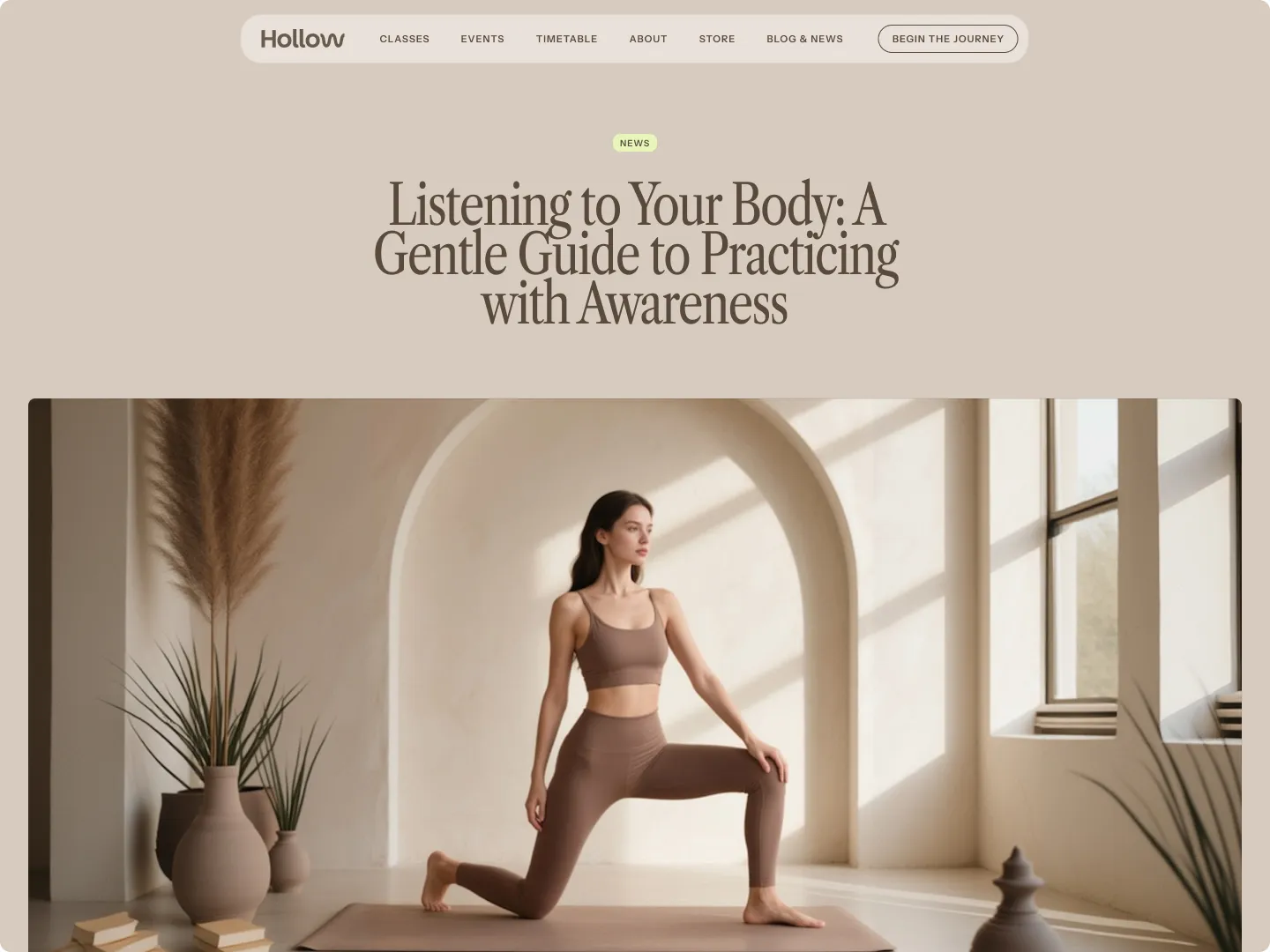 Woman in brown workout clothes doing a lunge stretch on a yoga mat in a light-filled room with arched wall and potted plants.