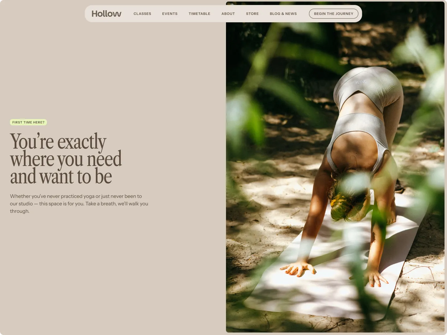 Person doing downward dog yoga pose on a mat outdoors with blurred green foliage in the foreground.
