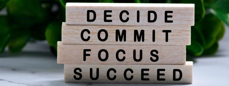 Stacked blocks with Decide, Commit, Focus, Succeed on each. Symbolizing customer advocacy success requires shared commitment.