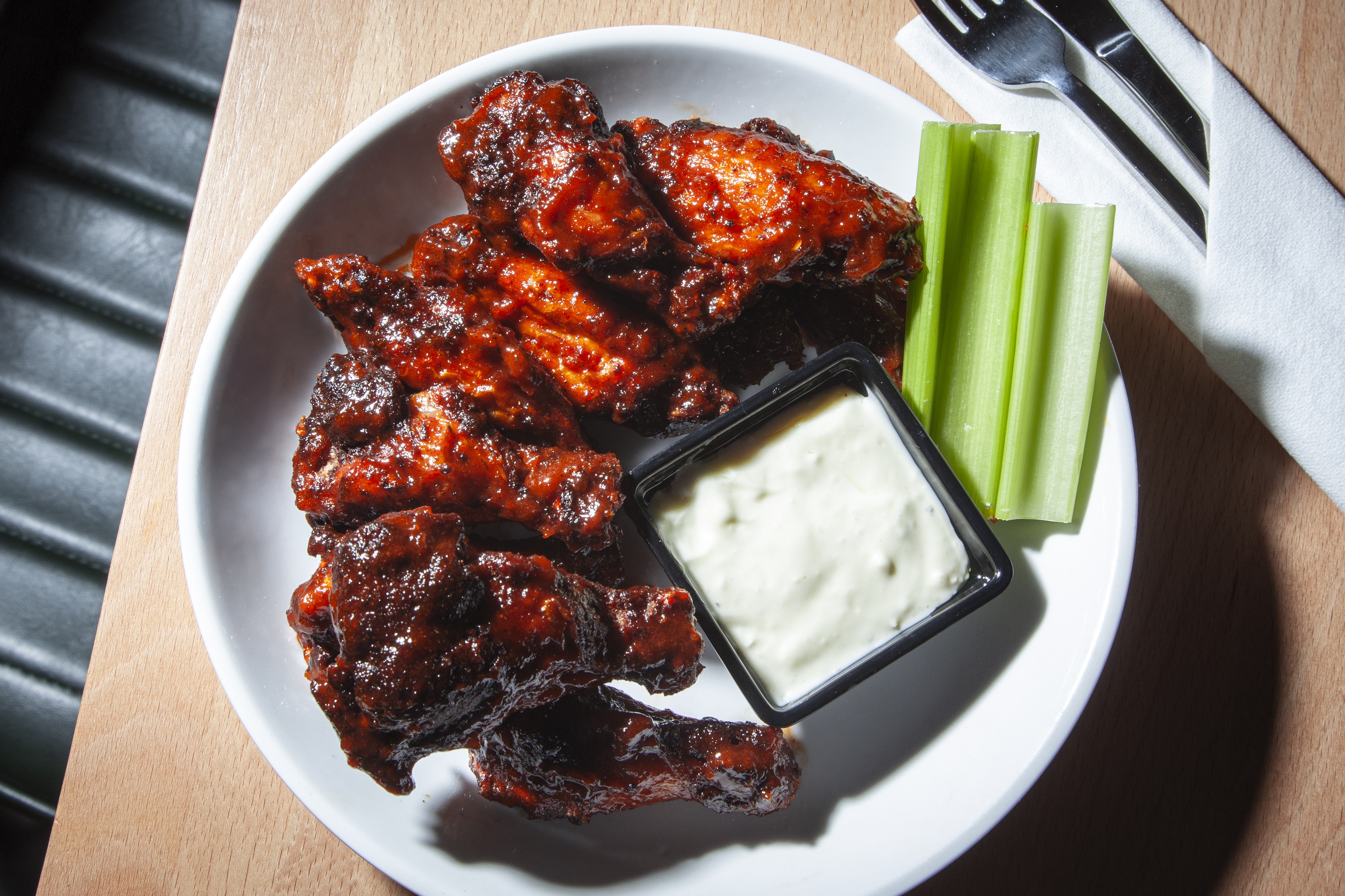 Crispy fried croquettes served on a white plate with roasted garlic aioli dipping sauce at DeWolf Brewing, Victor NY